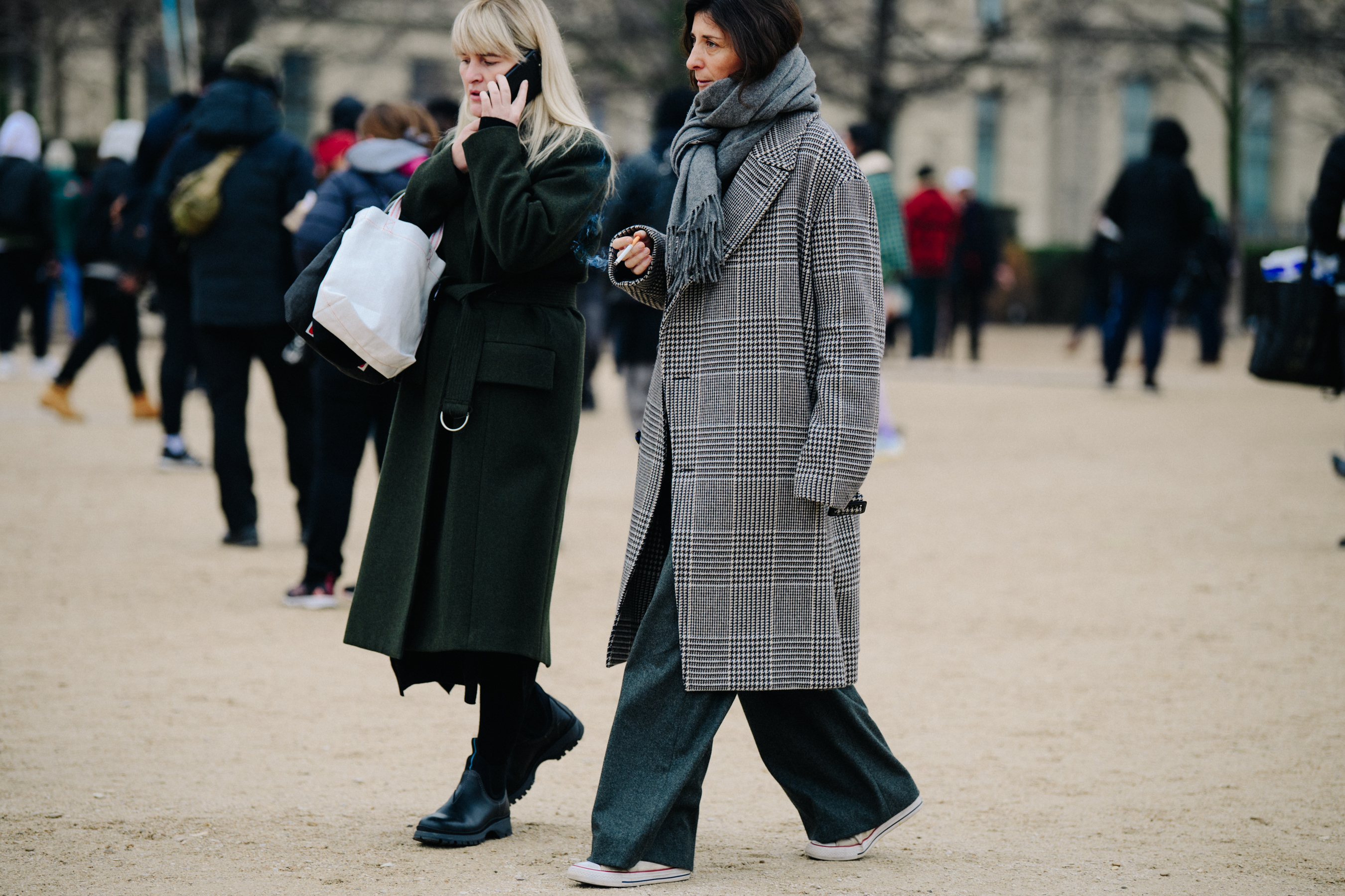 Two women wearing long winter coats