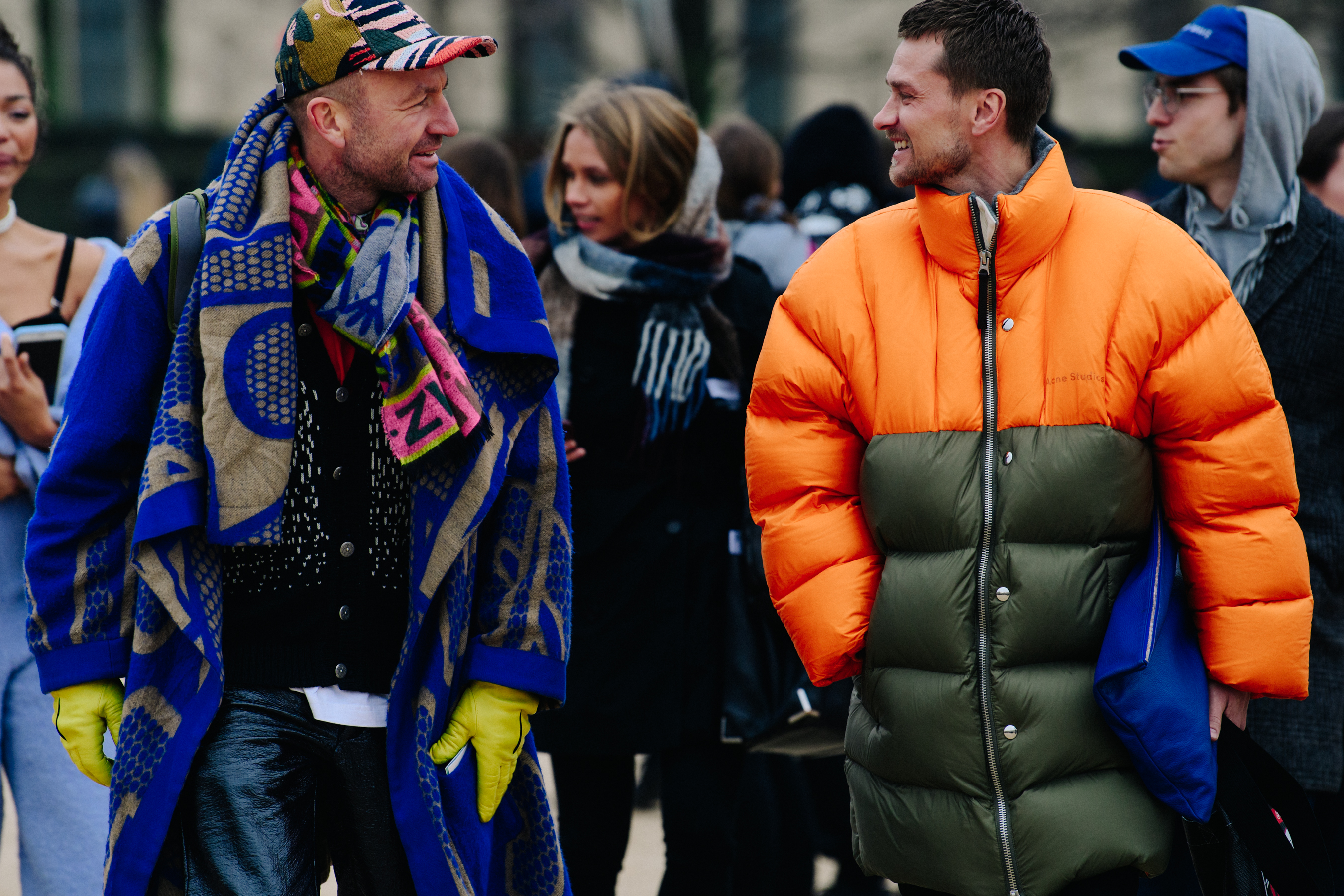 Two men wearing blue and orange