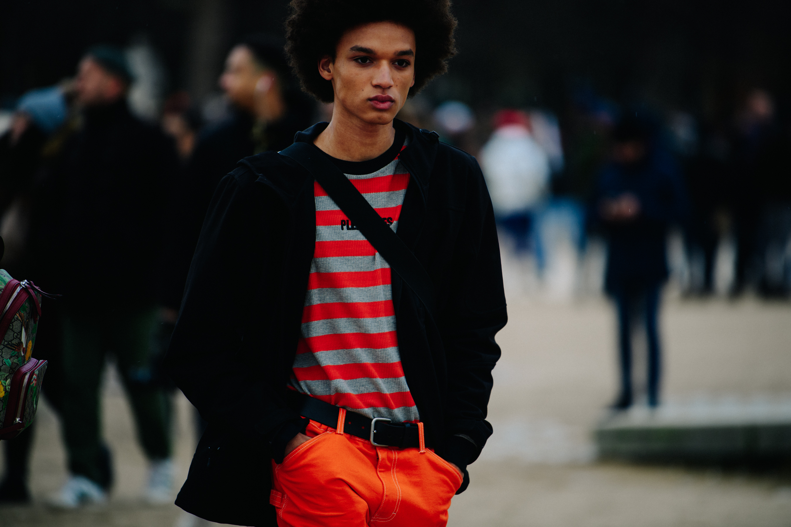 Model wearing orange striped top