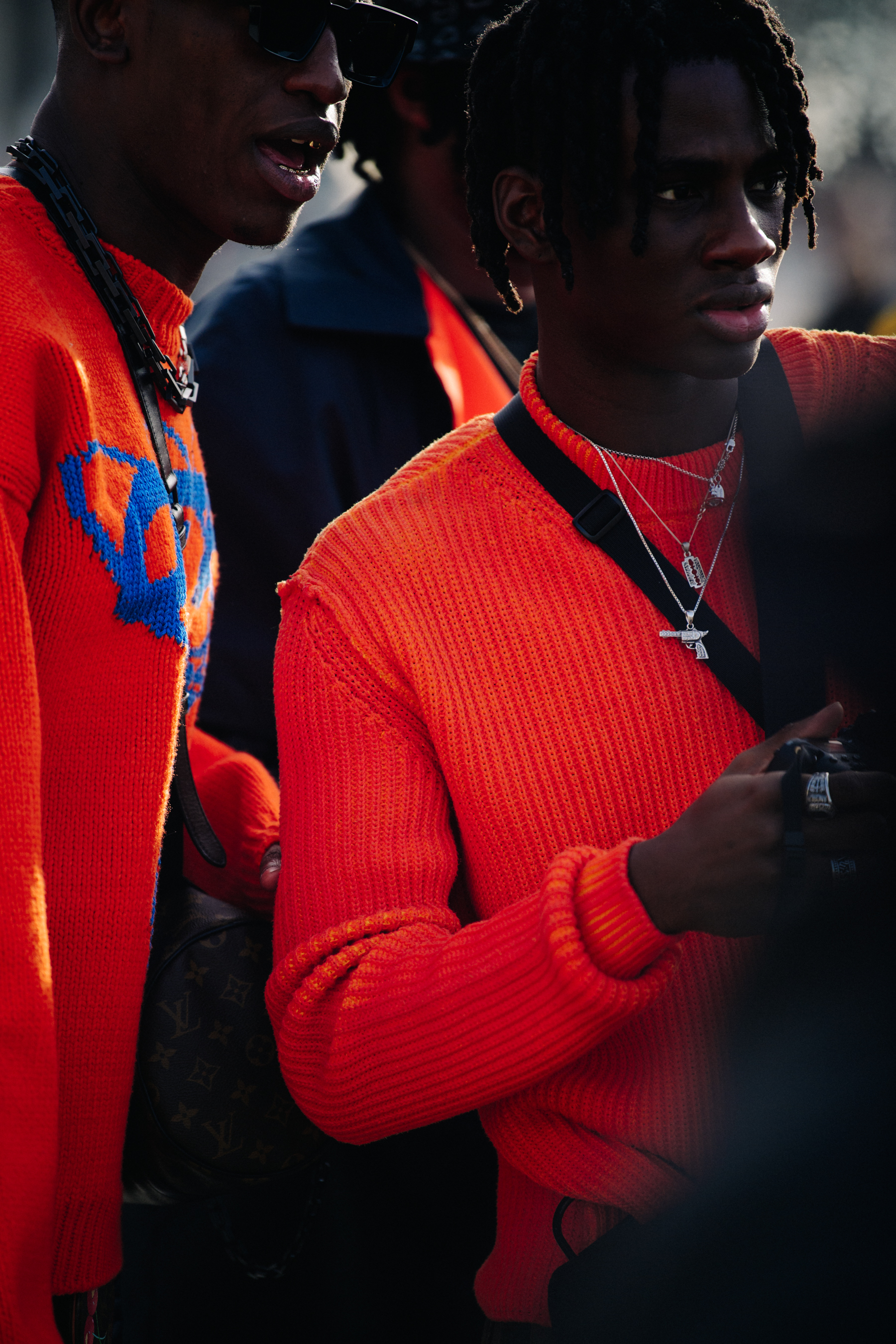 Two men wearing orange jumpers