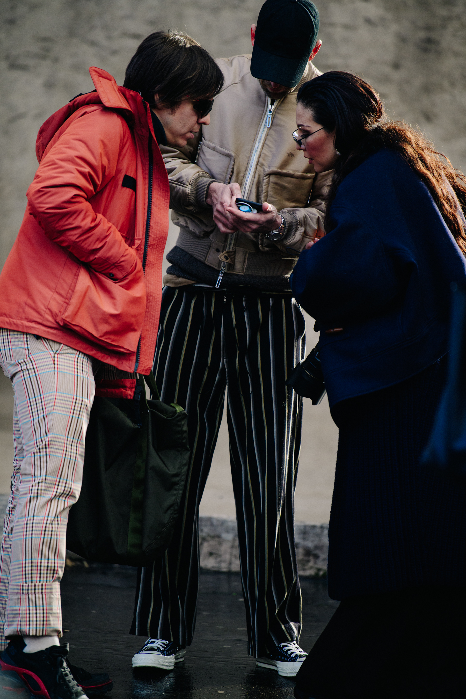 Three people wearing stylish clothing