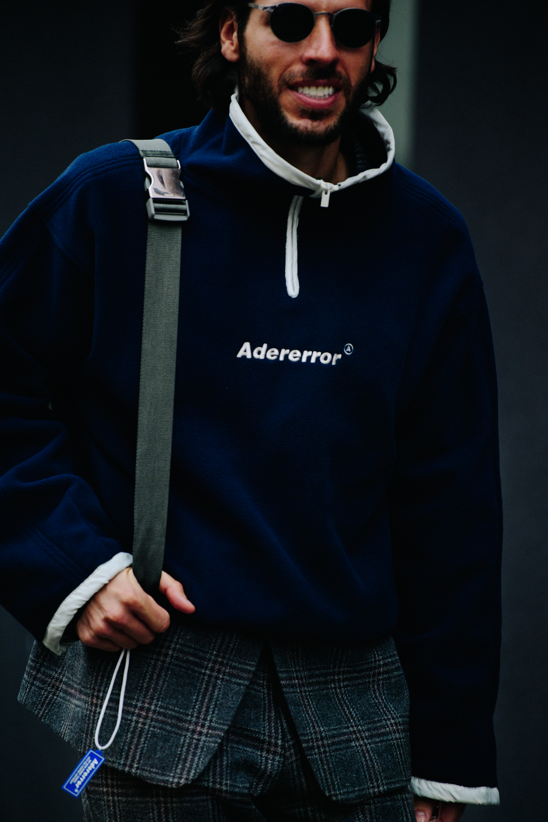 Man wearing Adererror top