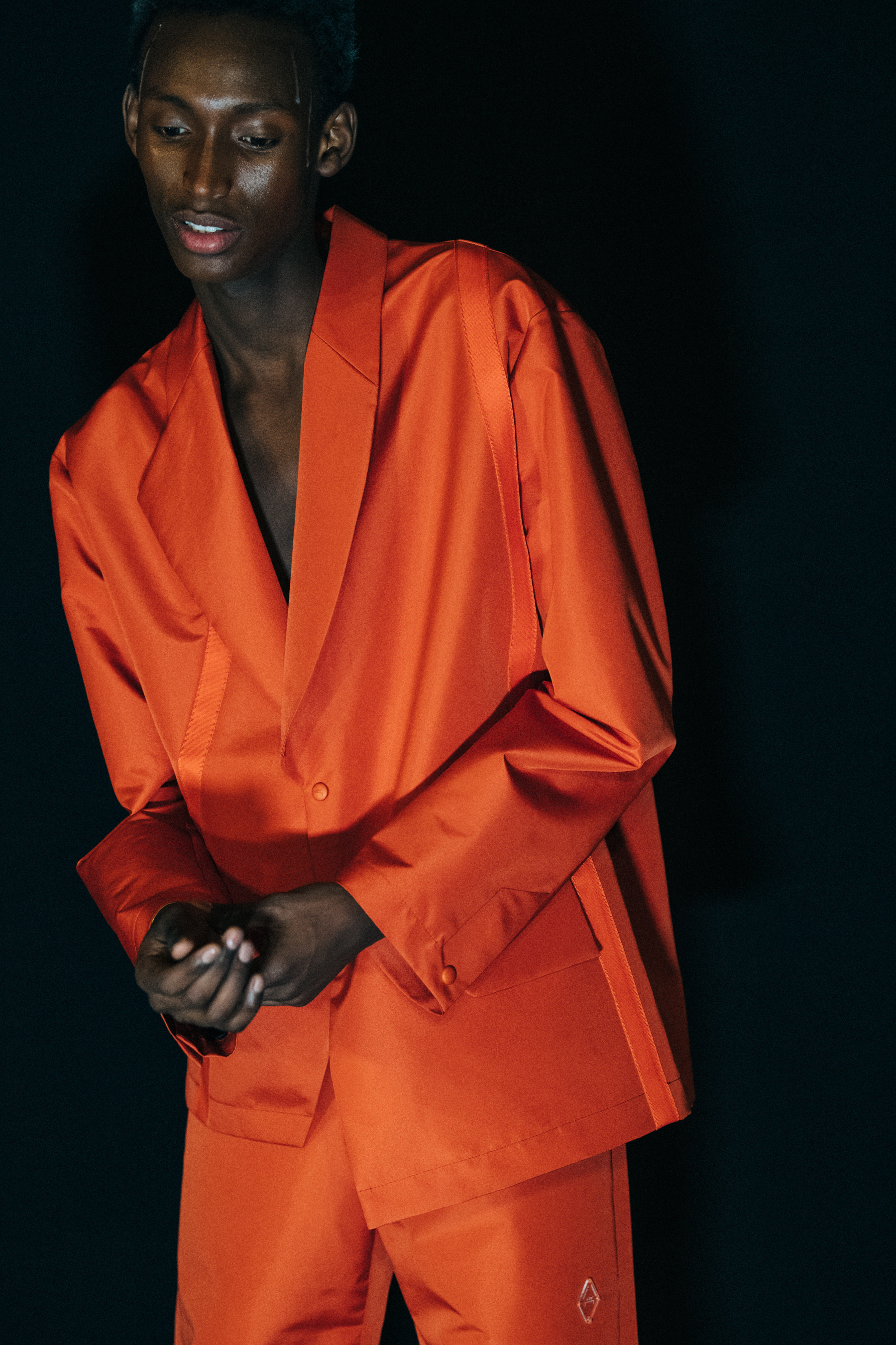 Model wearing orange outfit at A COLD WALL