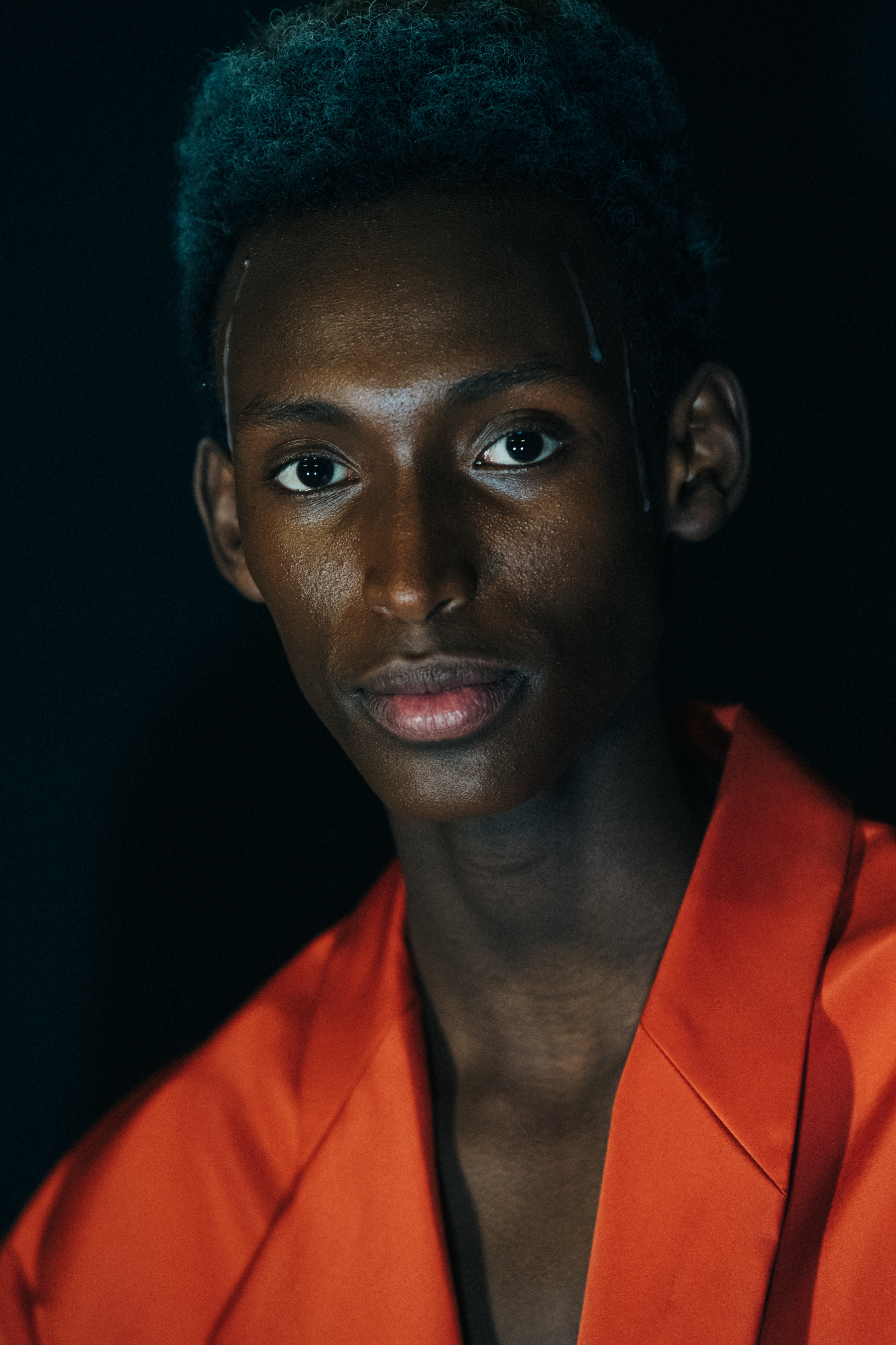 Model wearing orange outfit at A COLD WALL
