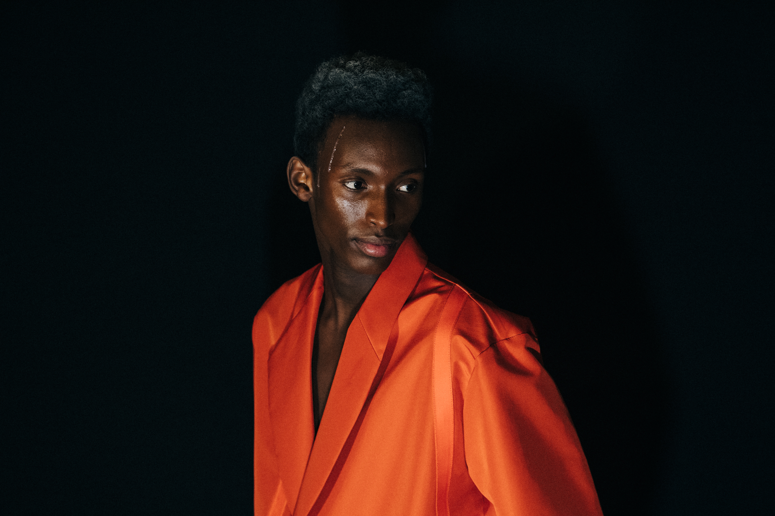 Model wearing orange outfit at A COLD WALL