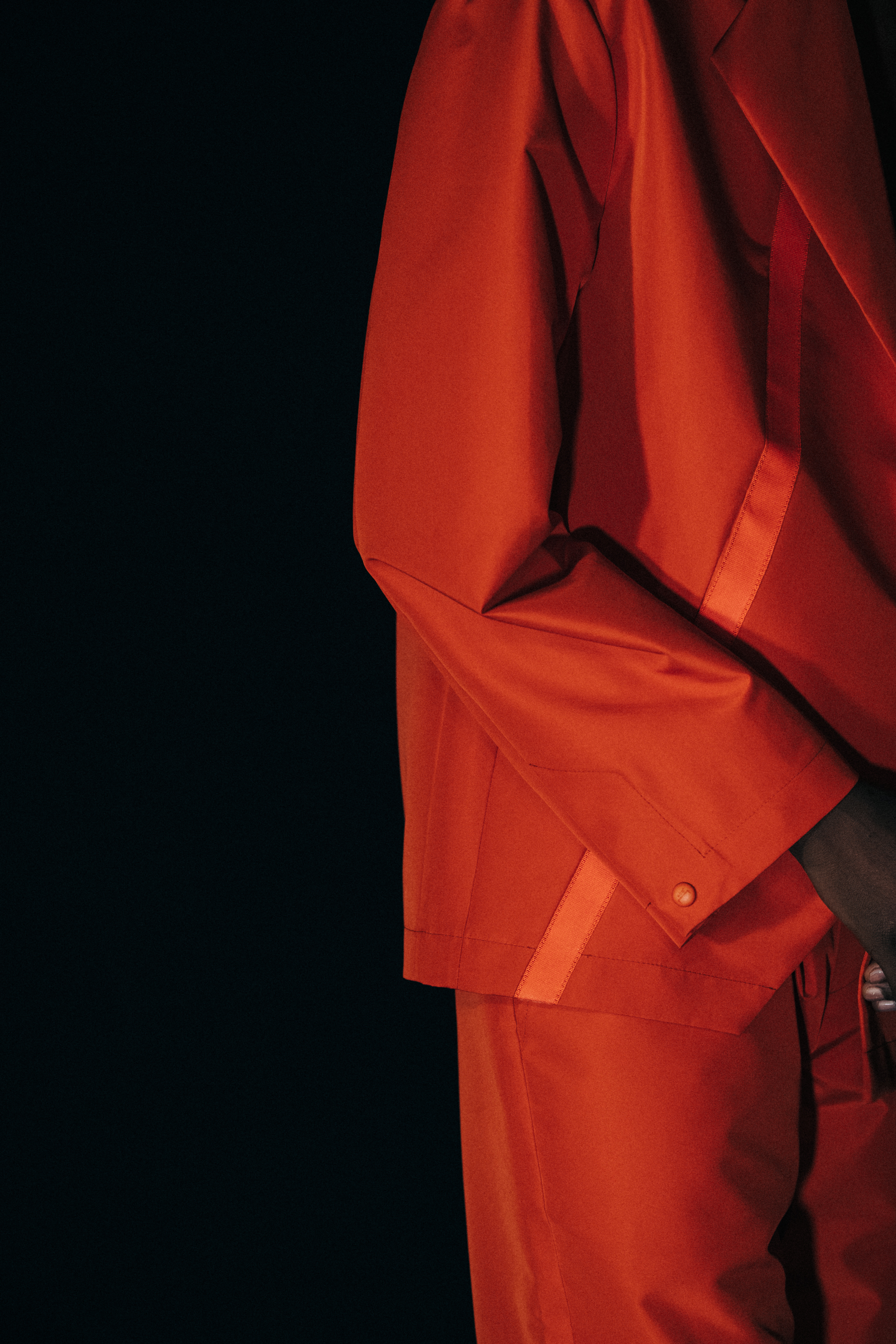 Model wearing orange outfit at A COLD WALL