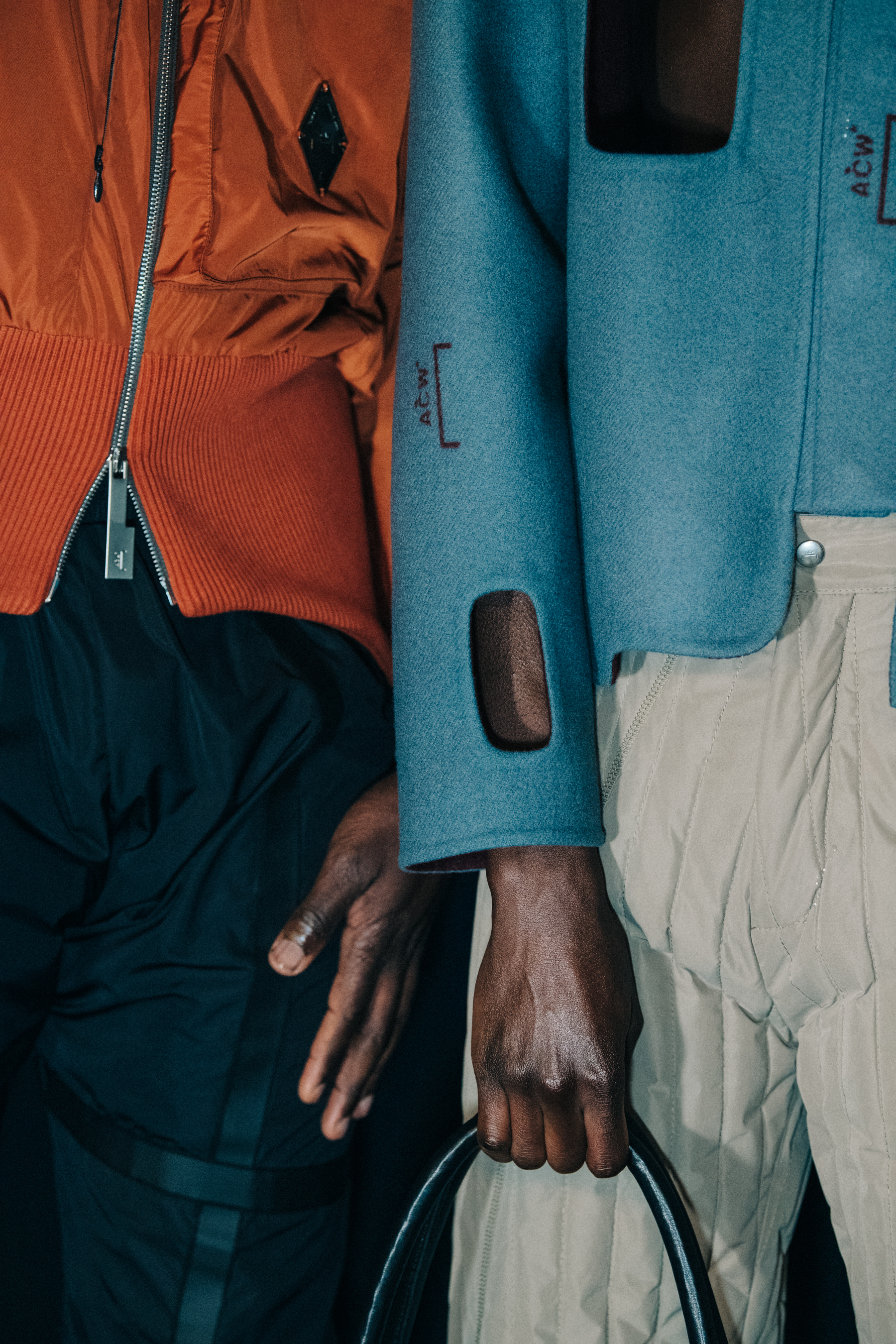 Models wearing orange and blue at A COLD WALL