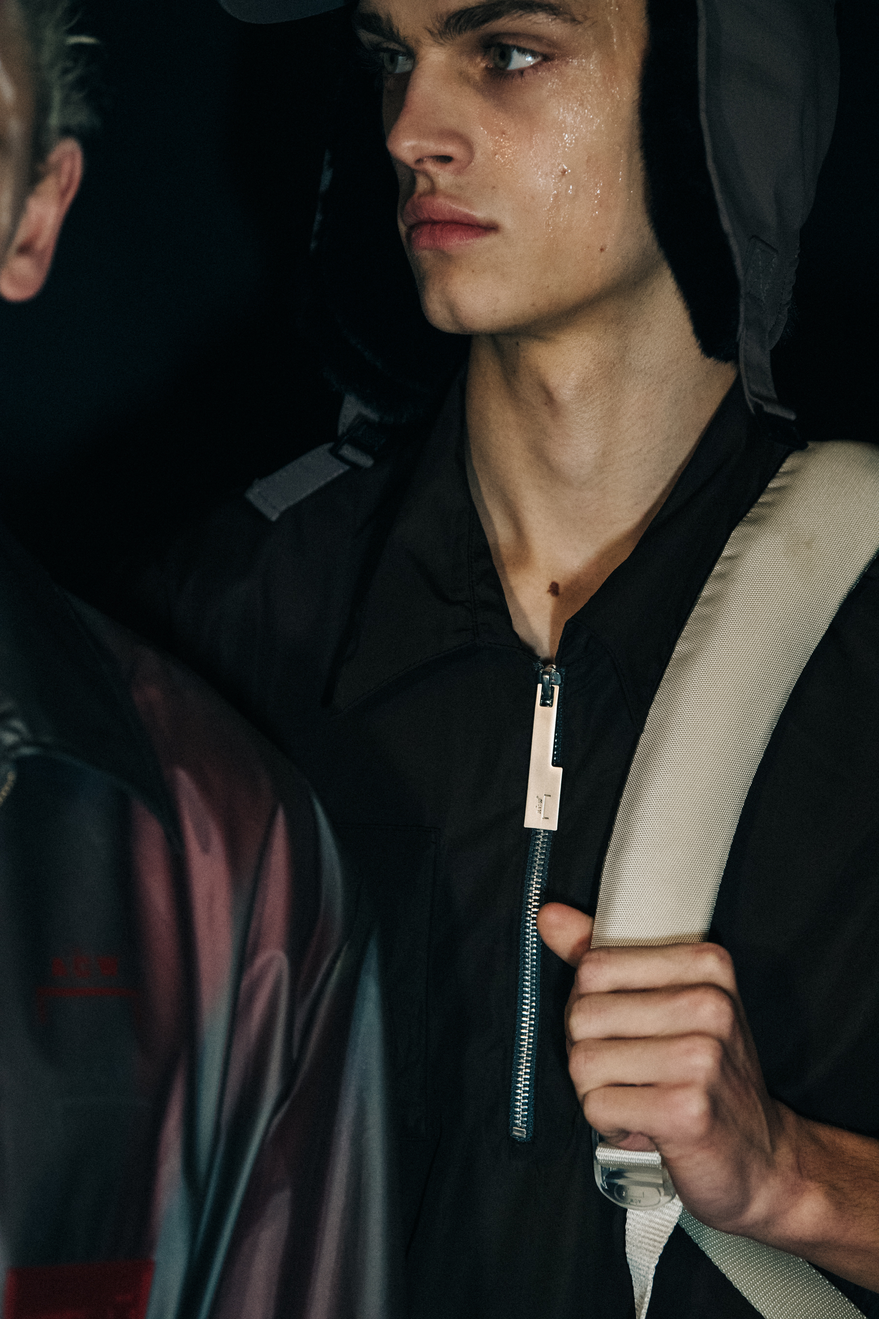 Model wearing hat backstage at A COLD WALL
