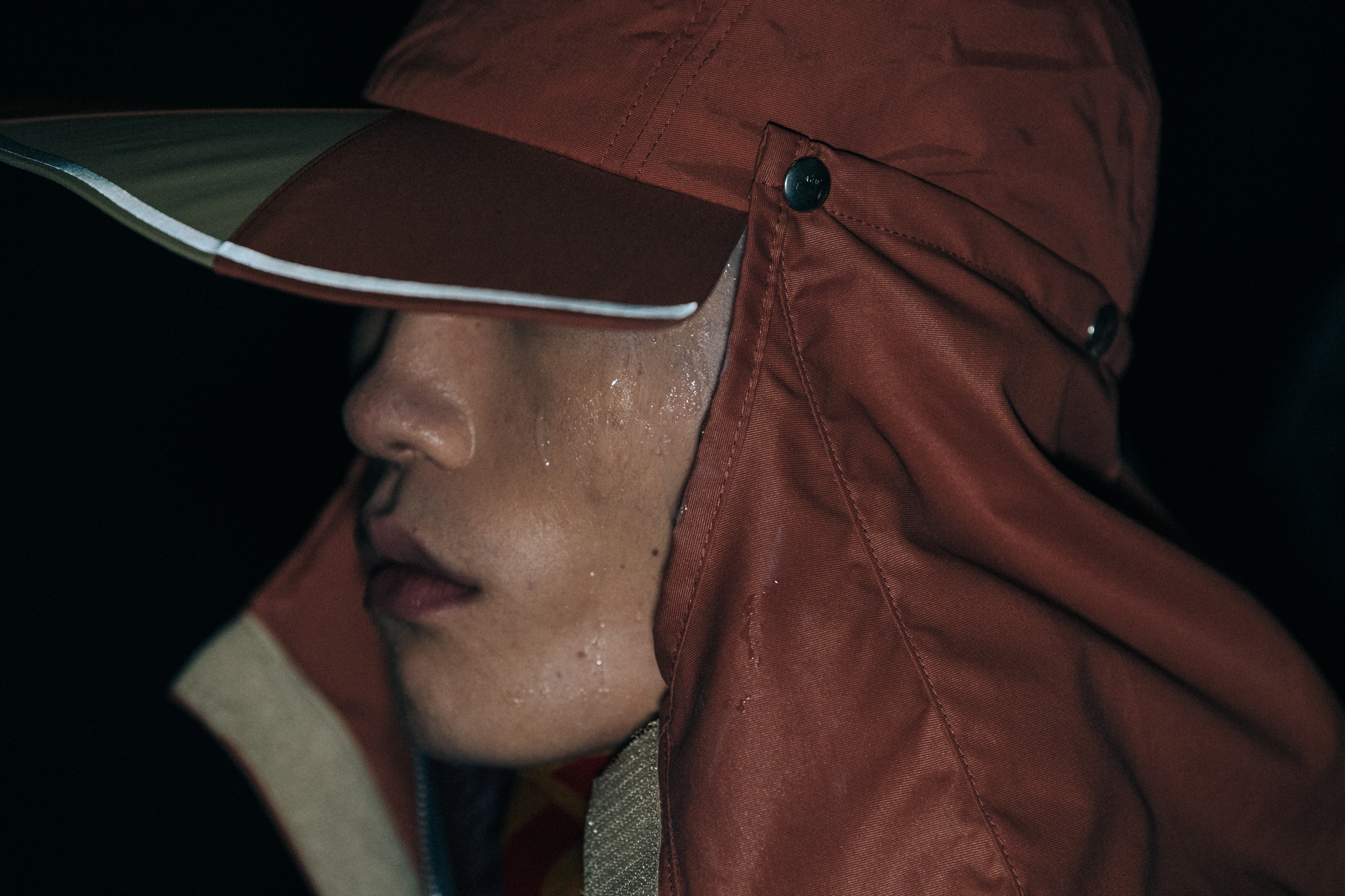 Model wearing hat backstage at A COLD WALL