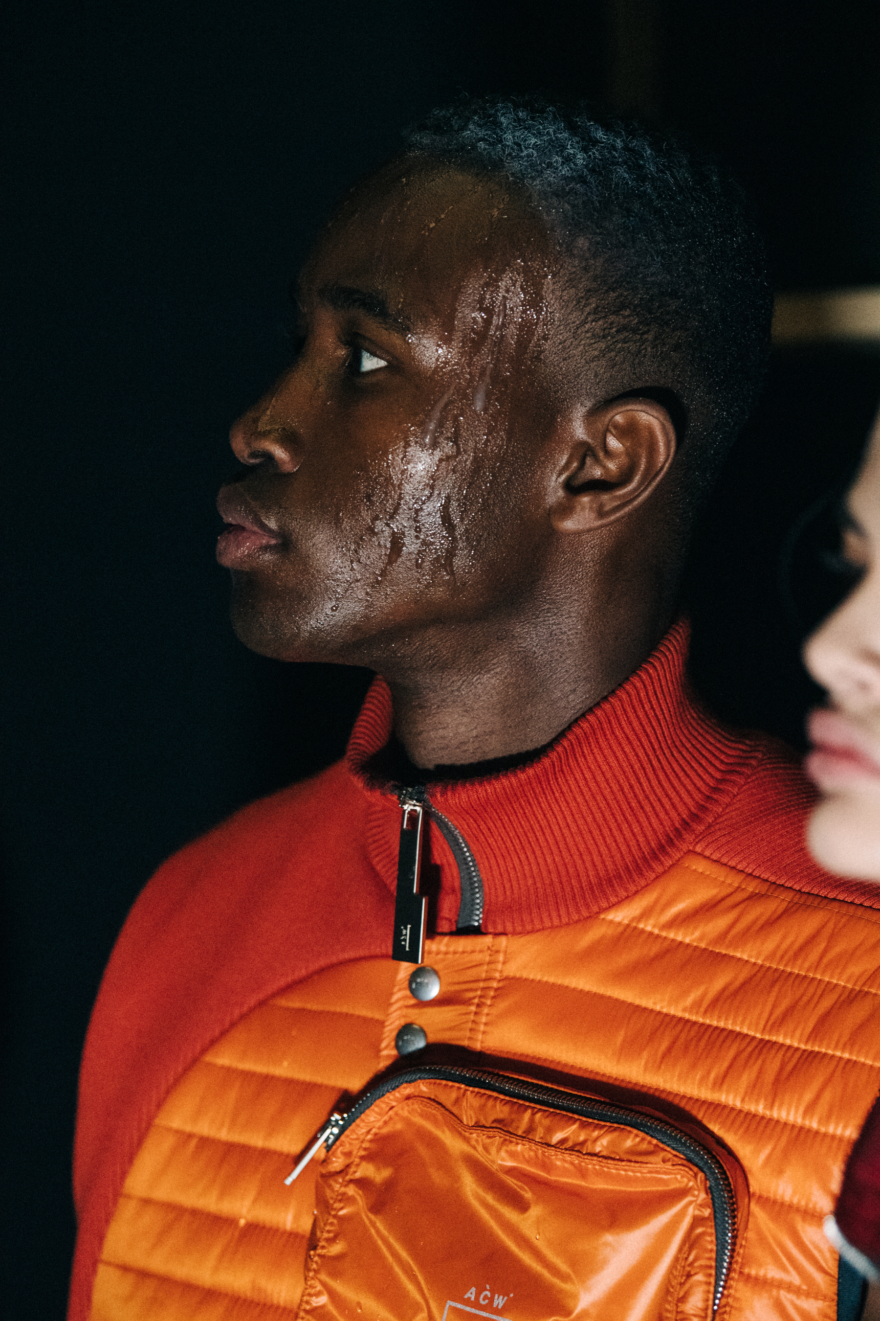 Model wearing orange outfit at A COLD WALL