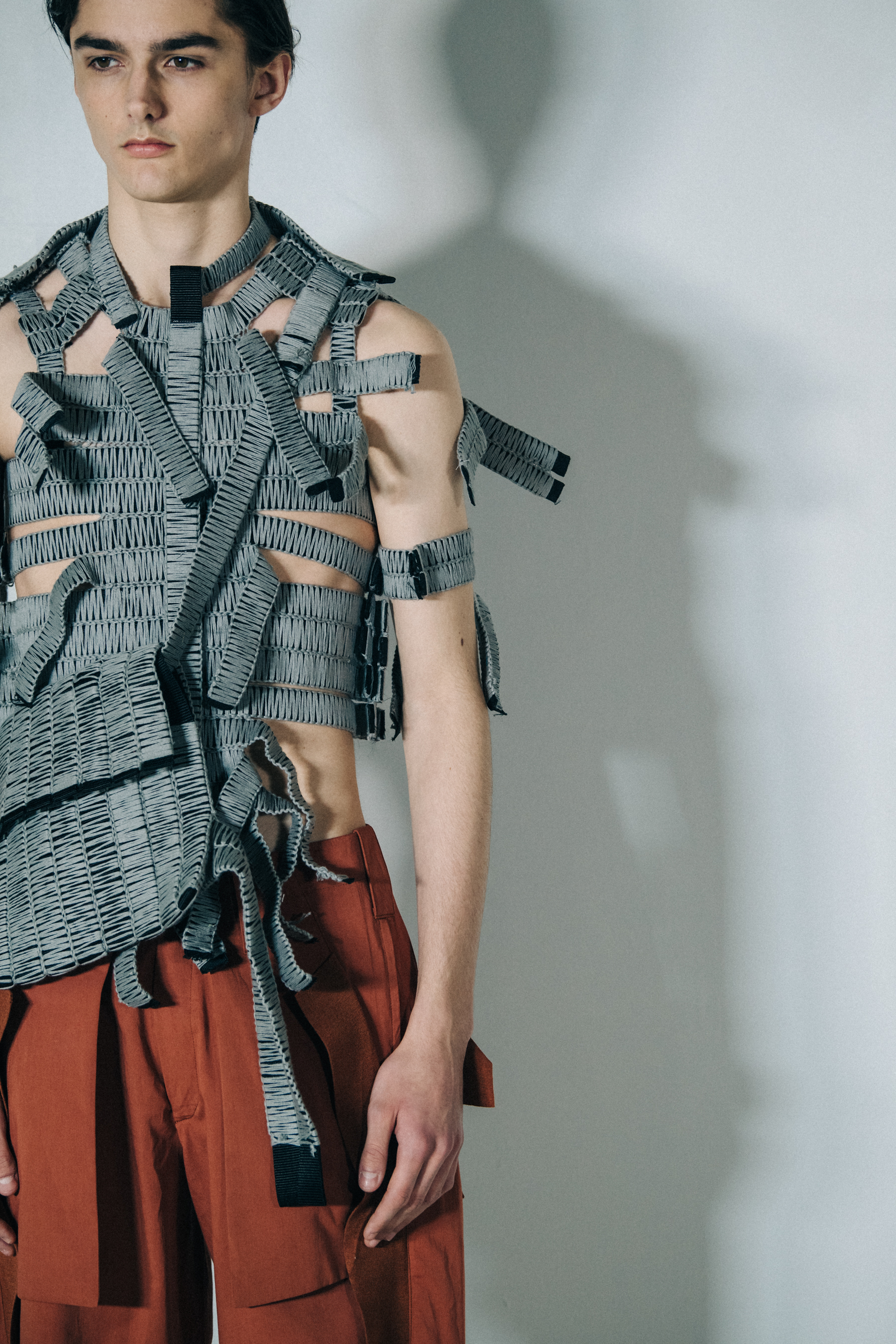 Model wearing grey vest top at Craig Green