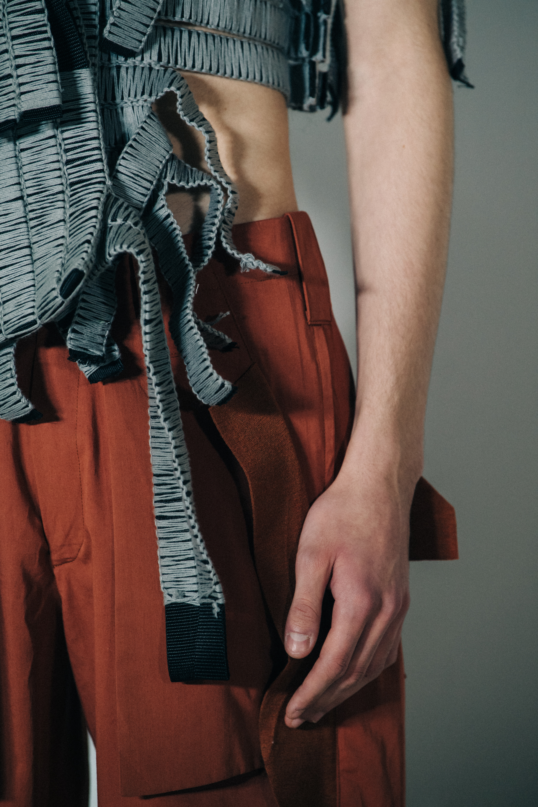Model wearing grey vest top at Craig Green