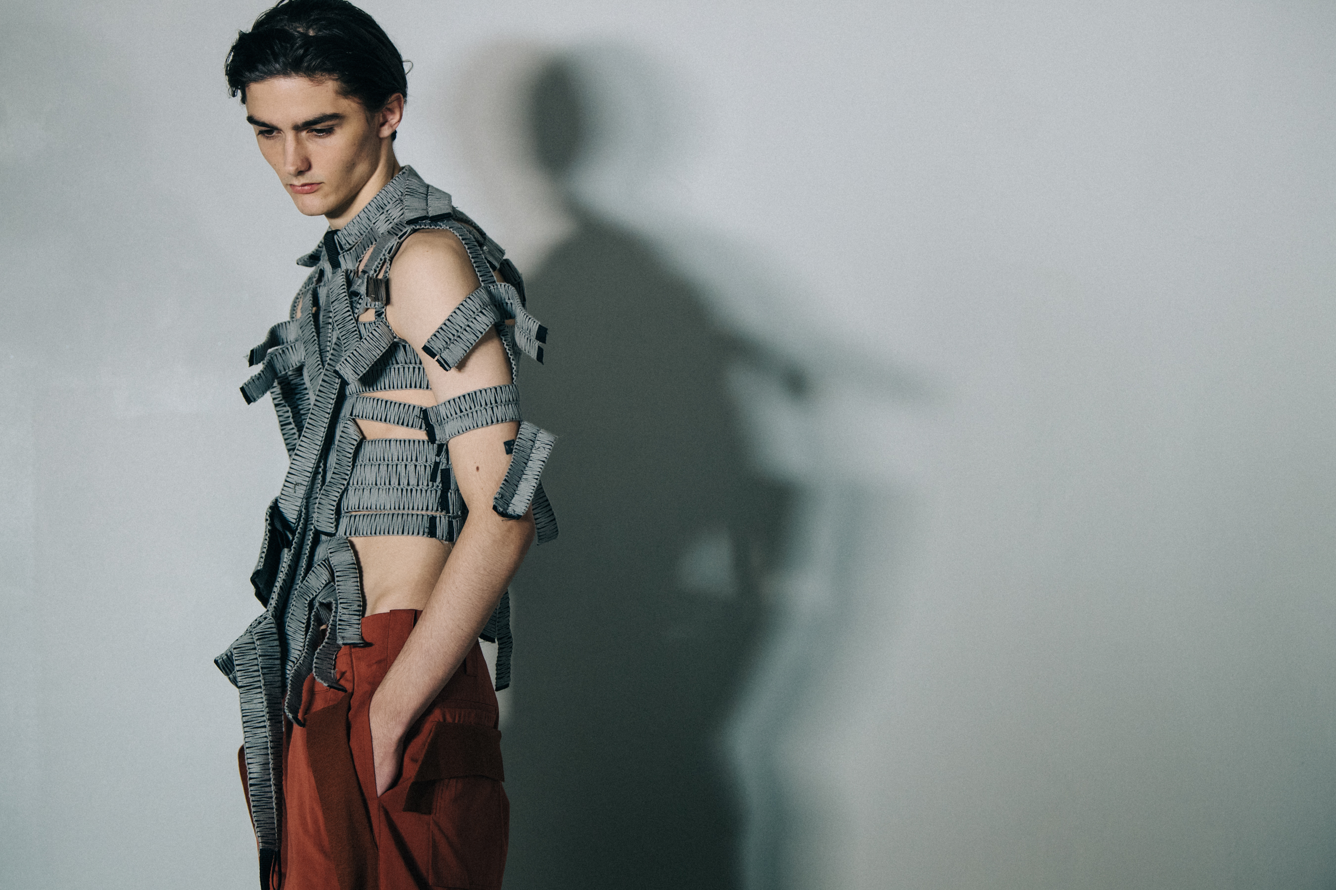 Model wearing grey vest top at Craig Green