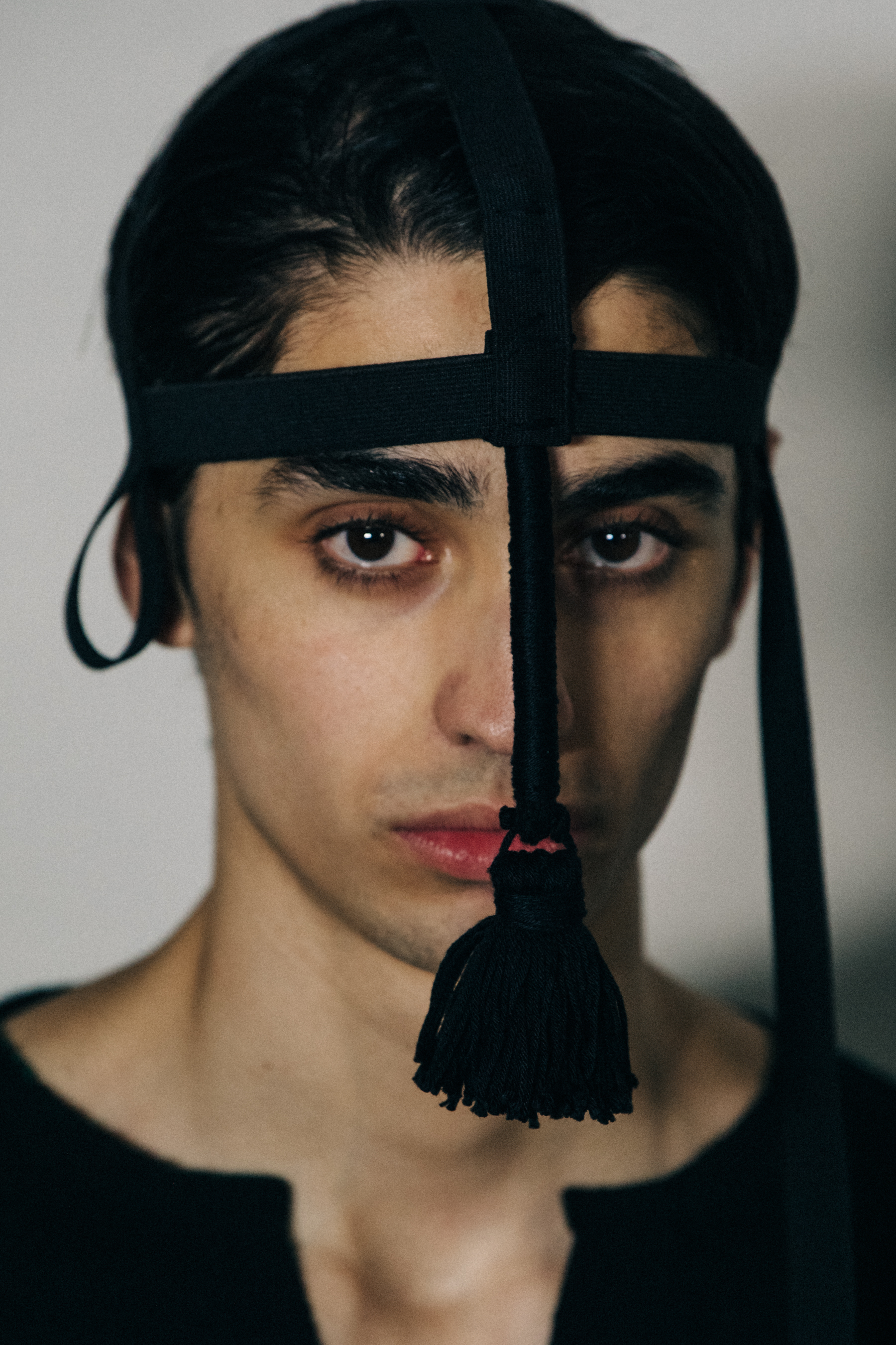 Portrait of model wearing black headpiece