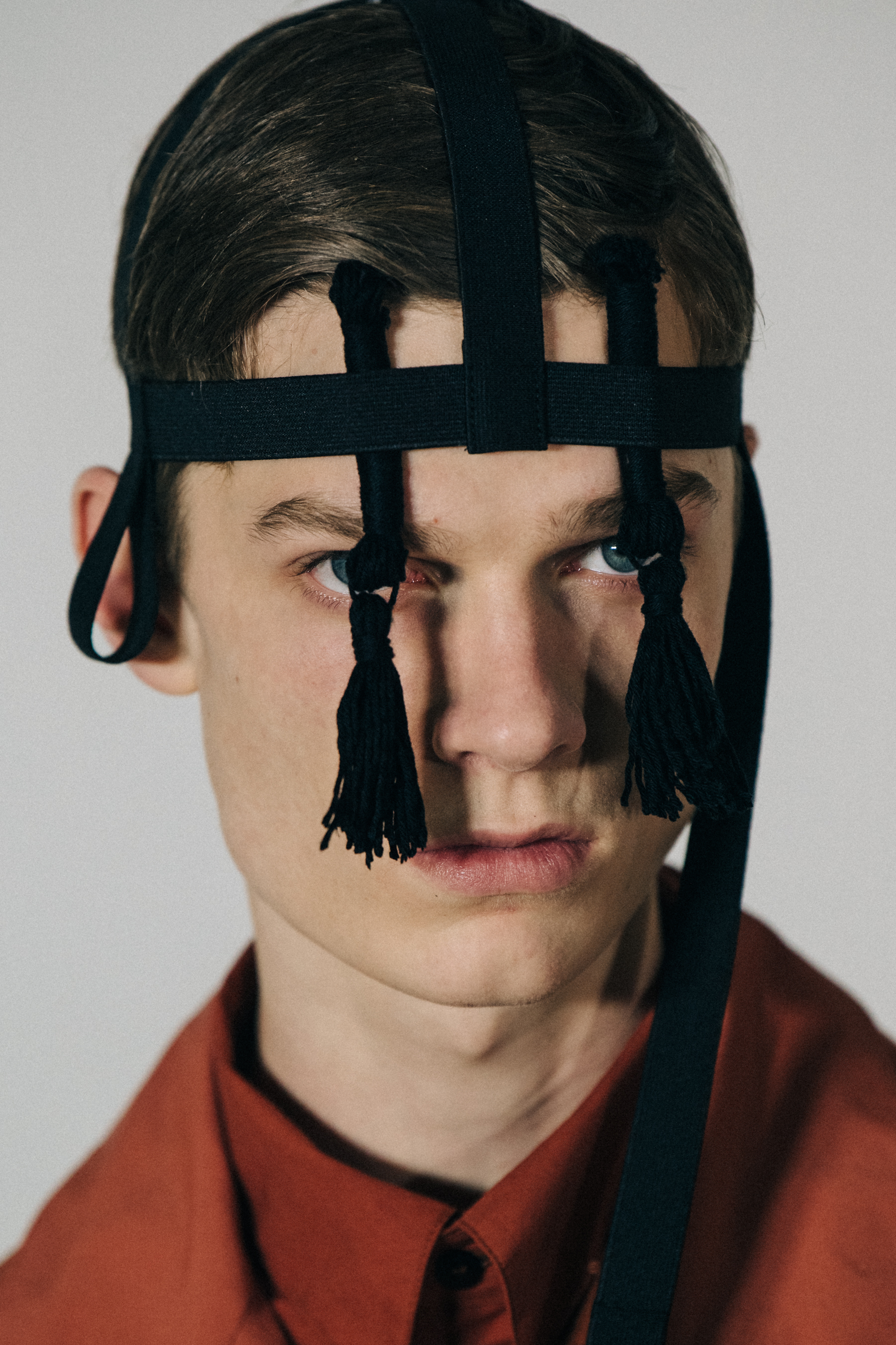 Portrait of model wearing black headpiece