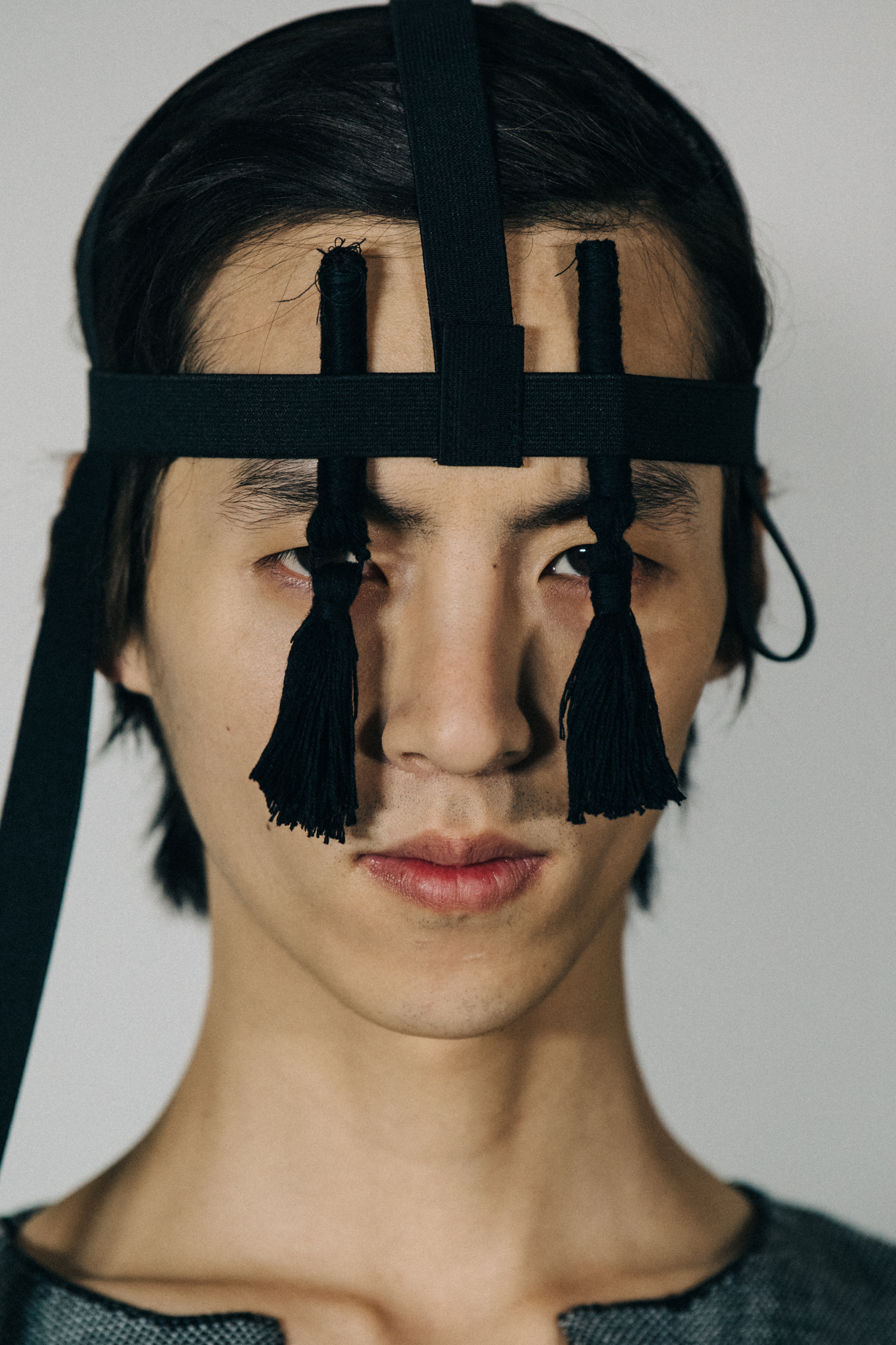 Portrait of model wearing black headpiece