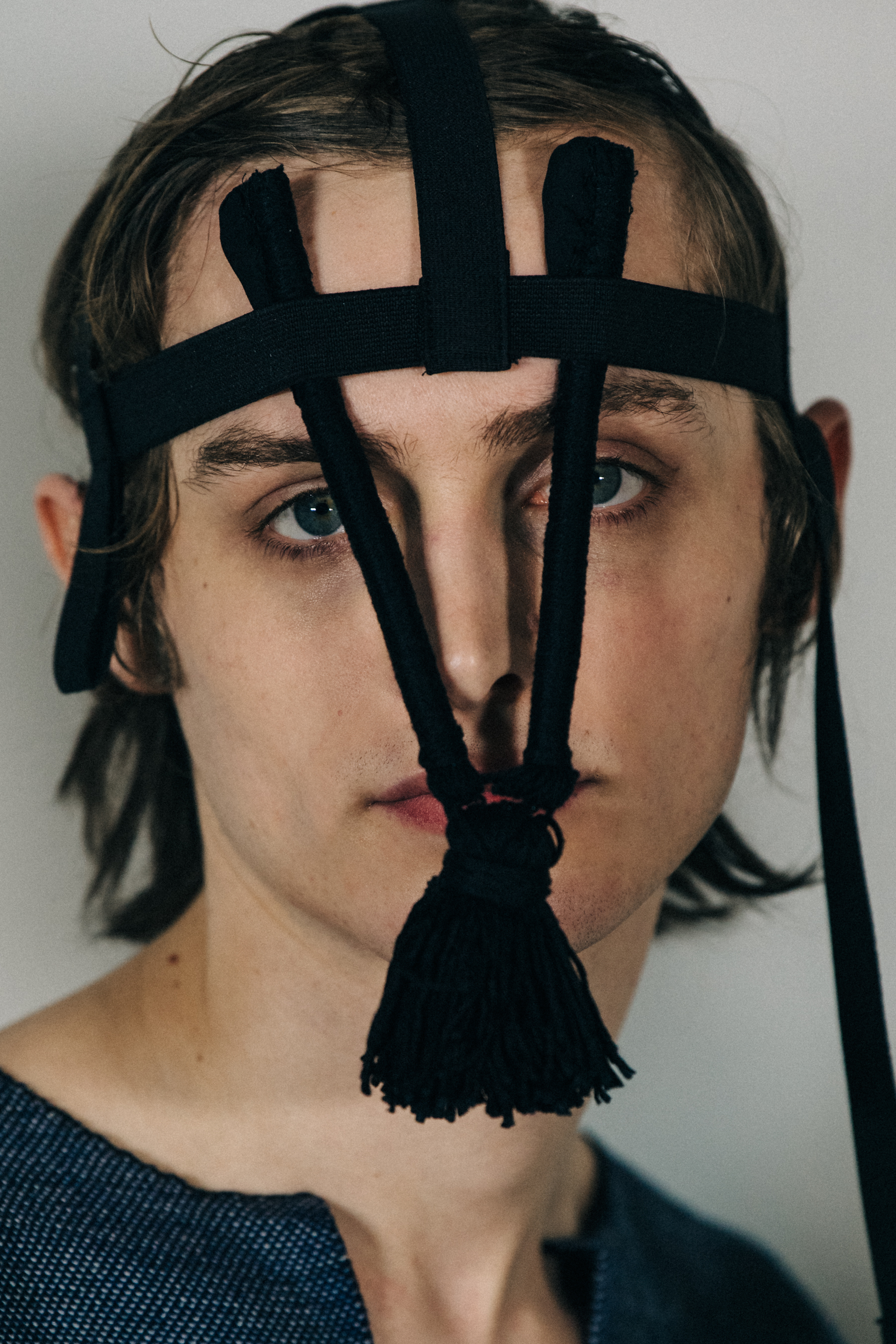 Portrait of model wearing black headpiece