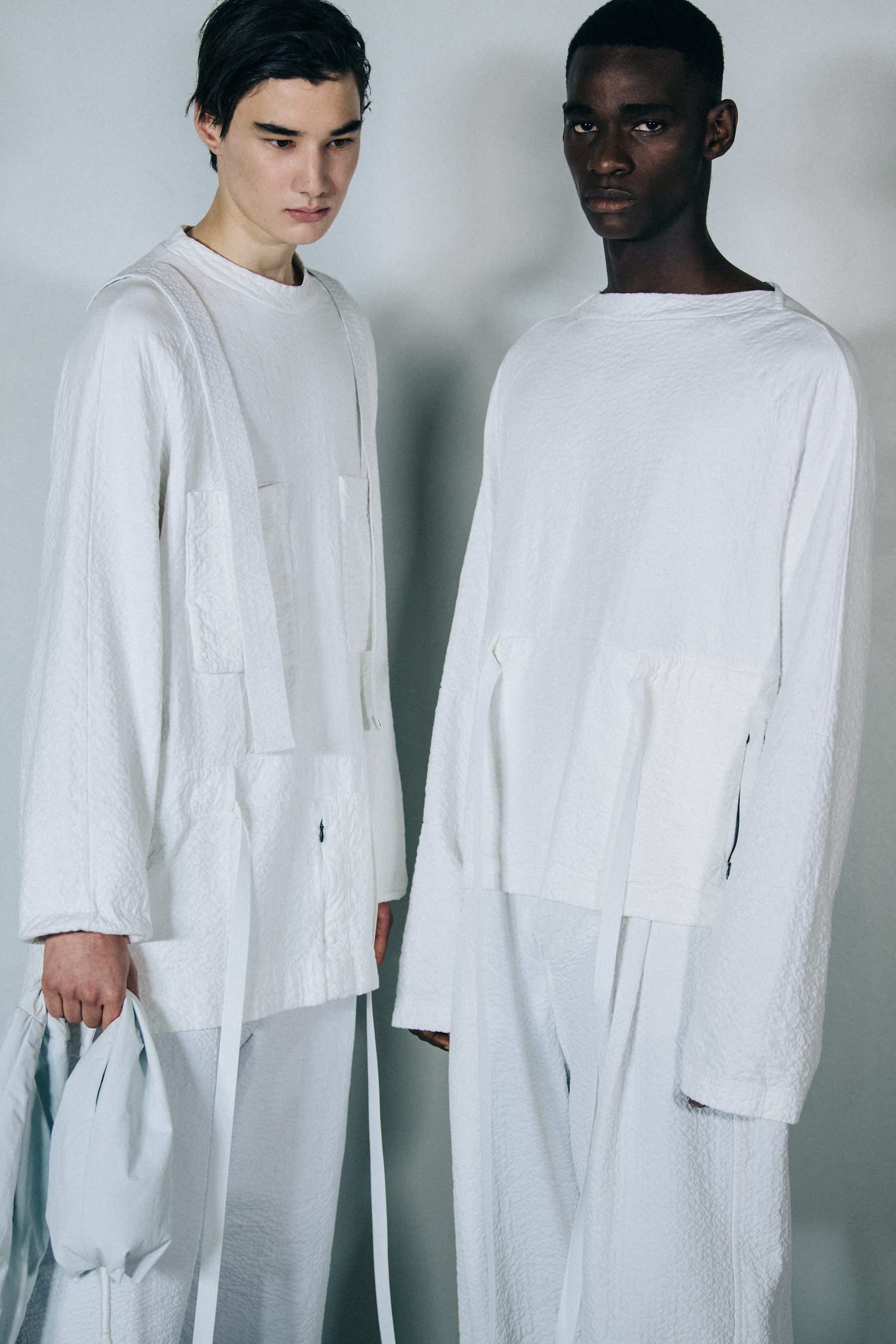 Models wearing light outfits at Craig Green