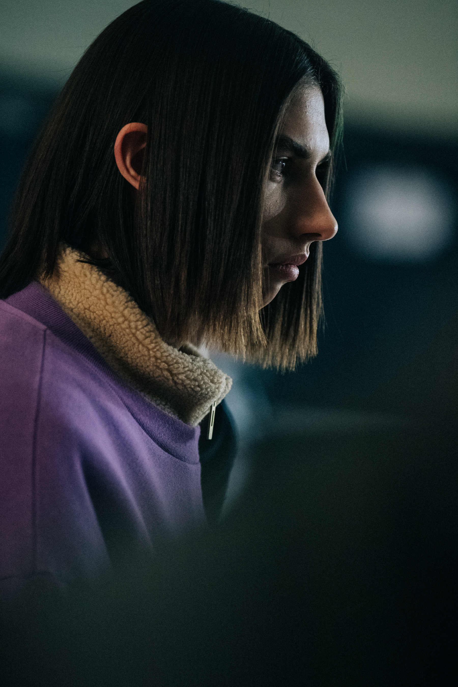 Model wearing sweater backstage