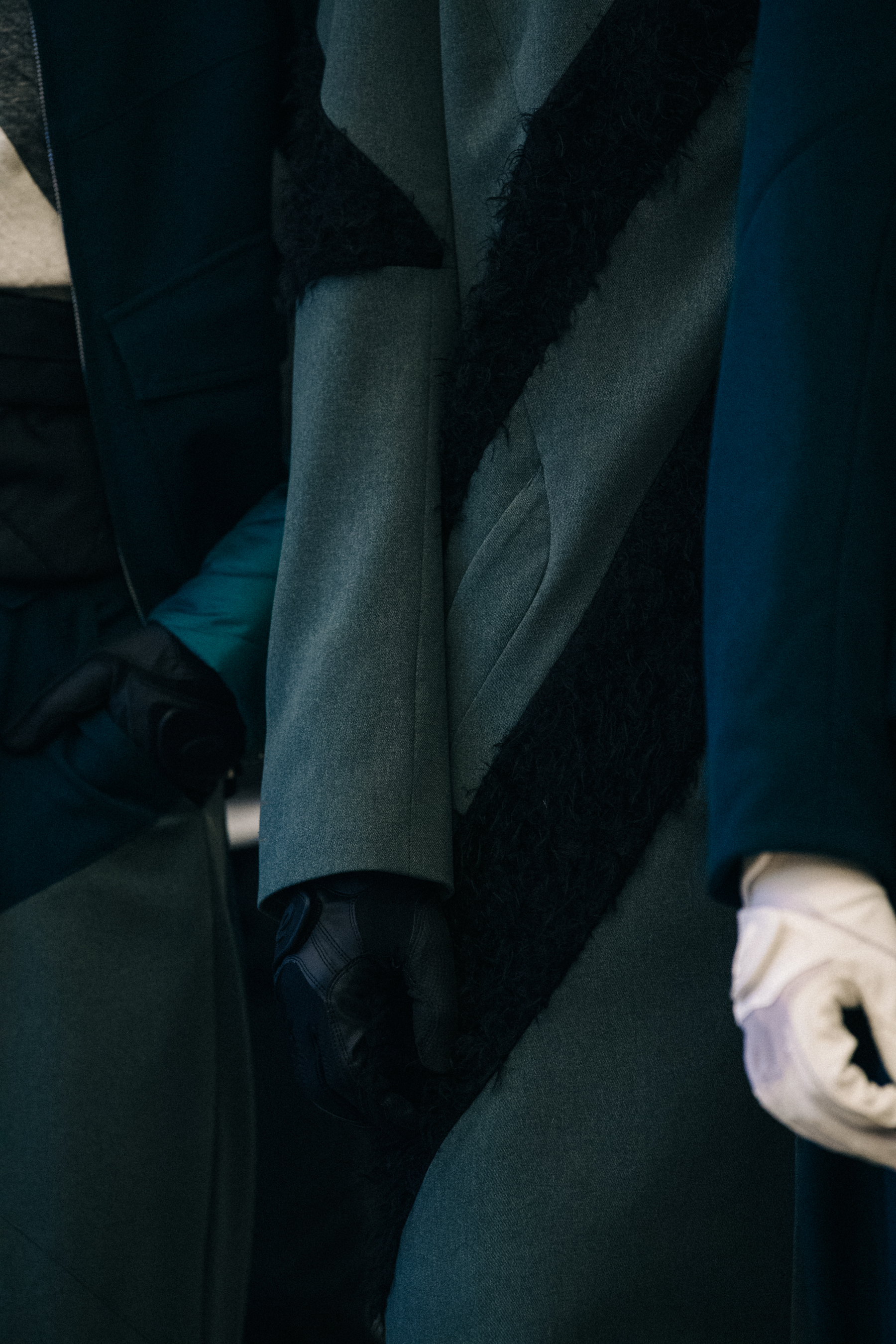 Models wearing white gloves backstage at Kiko Kostadinov
