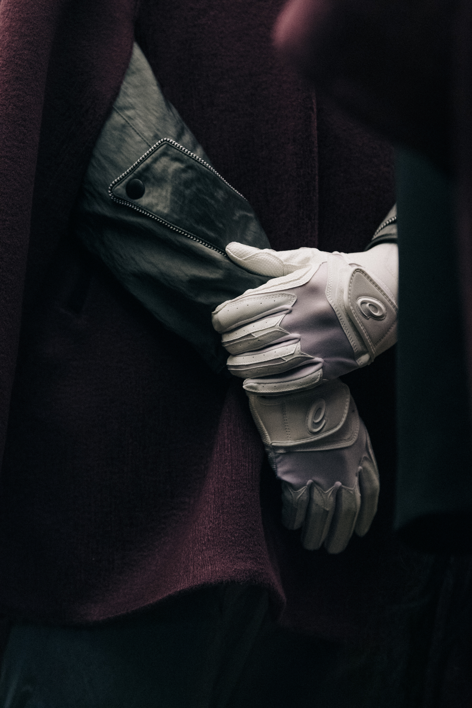 Models wearing white gloves backstage at Kiko Kostadinov