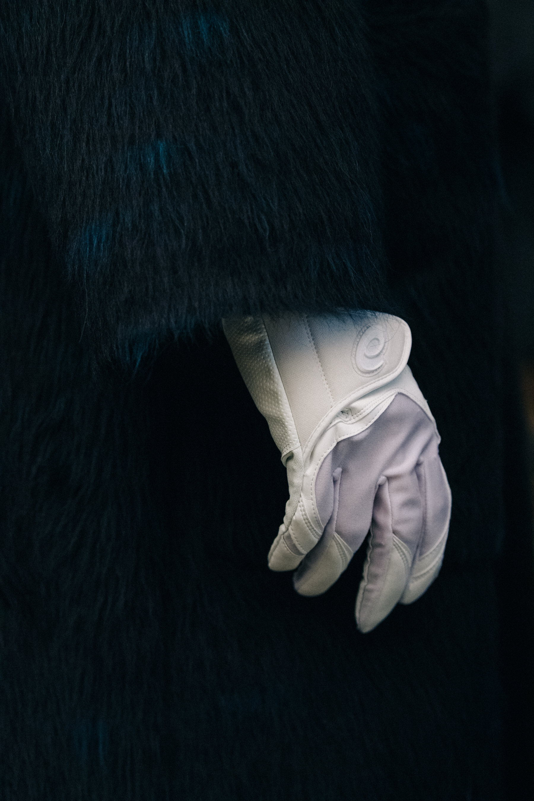 Models wearing white gloves backstage at Kiko Kostadinov