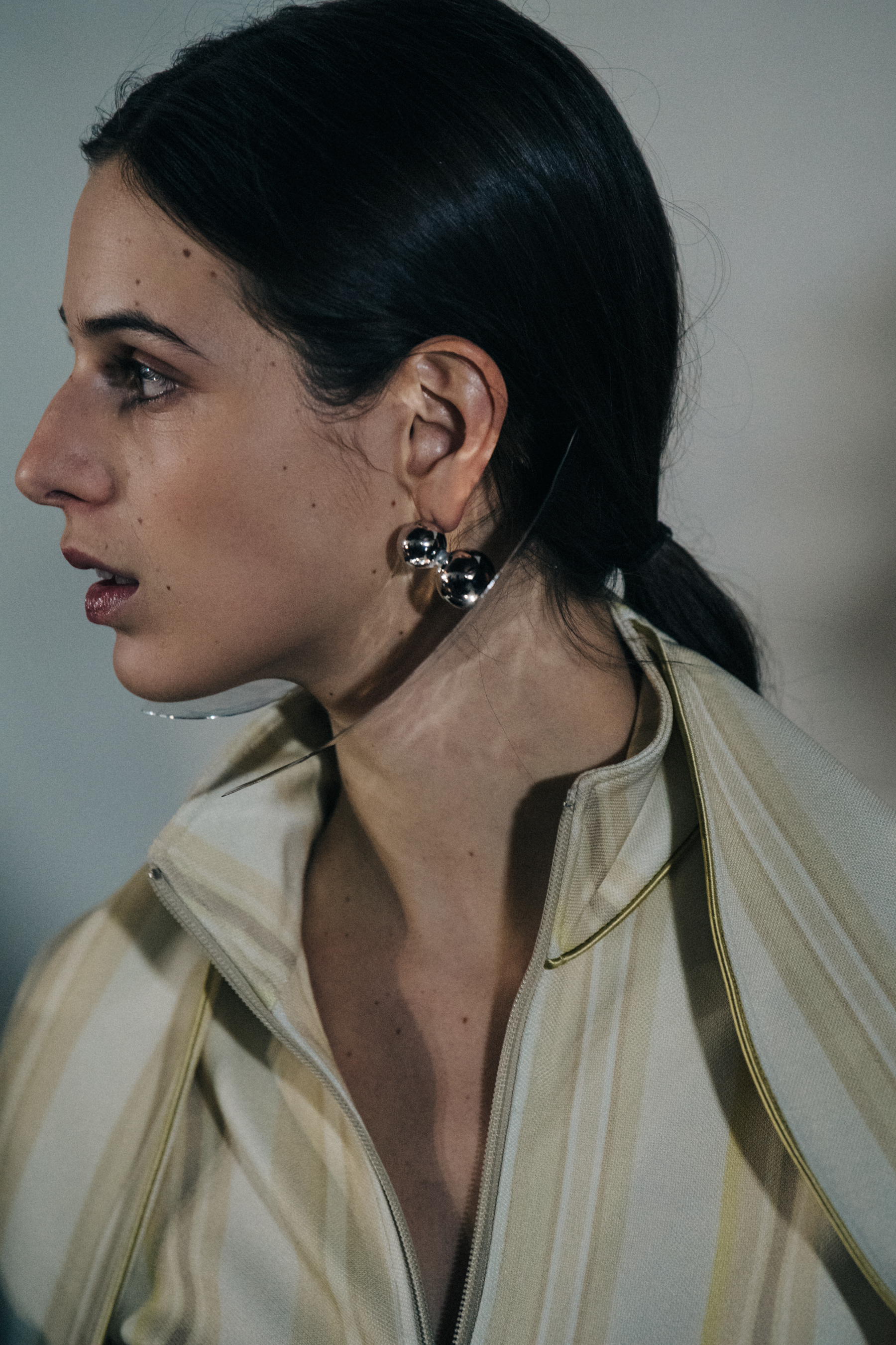Model wearing gold earrings at Y/Project