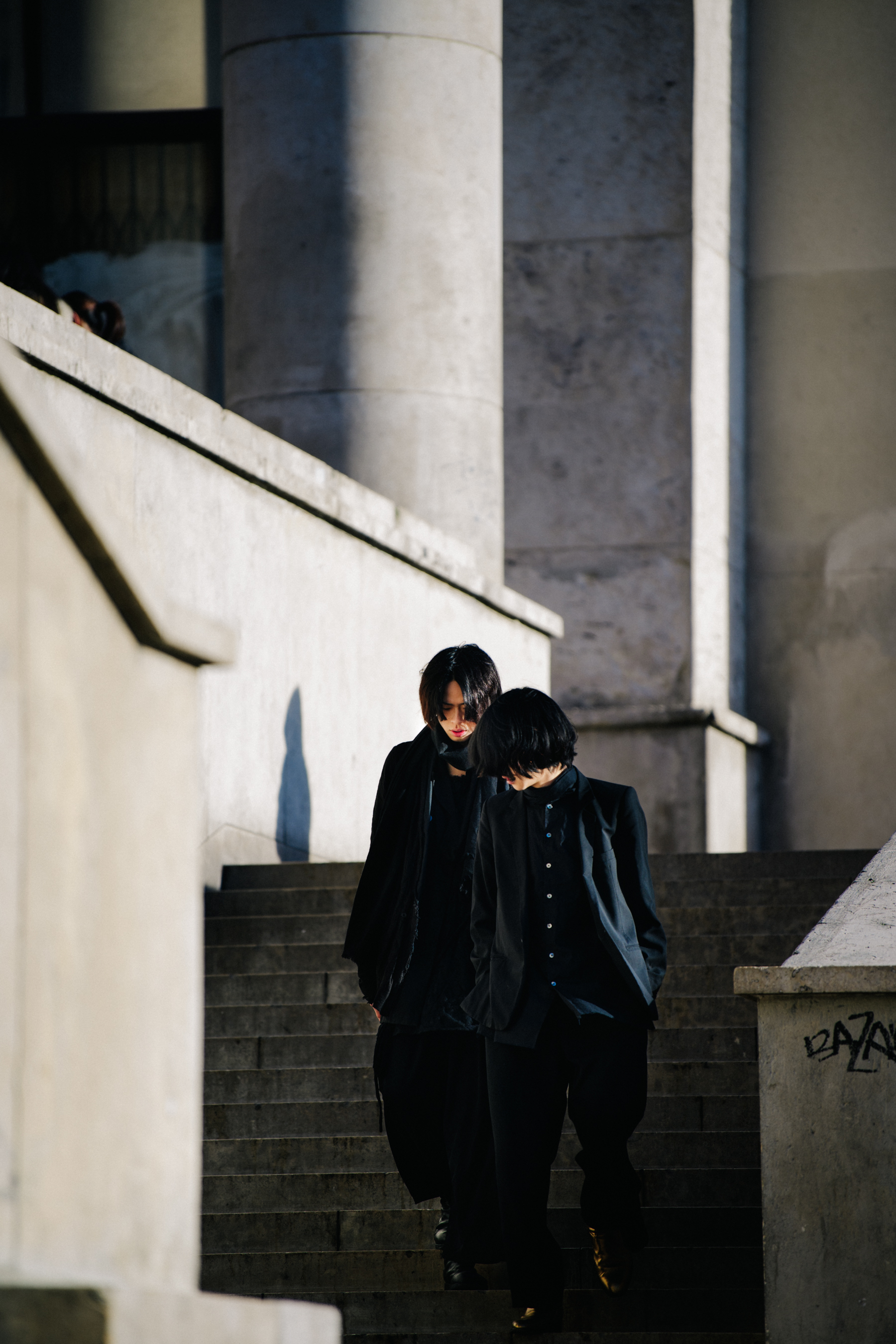 Two Asian men wearing black