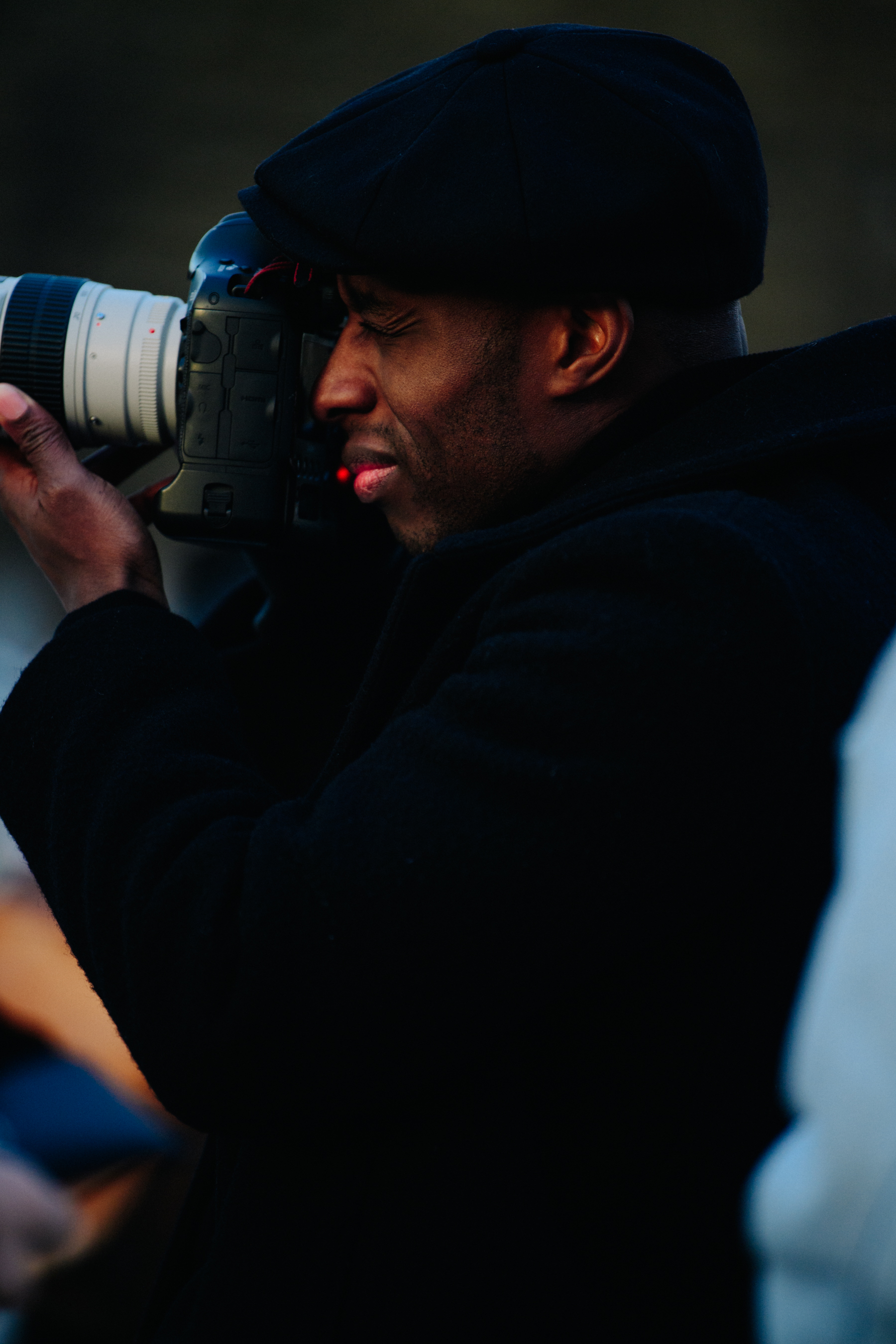 British man wearing dark hat