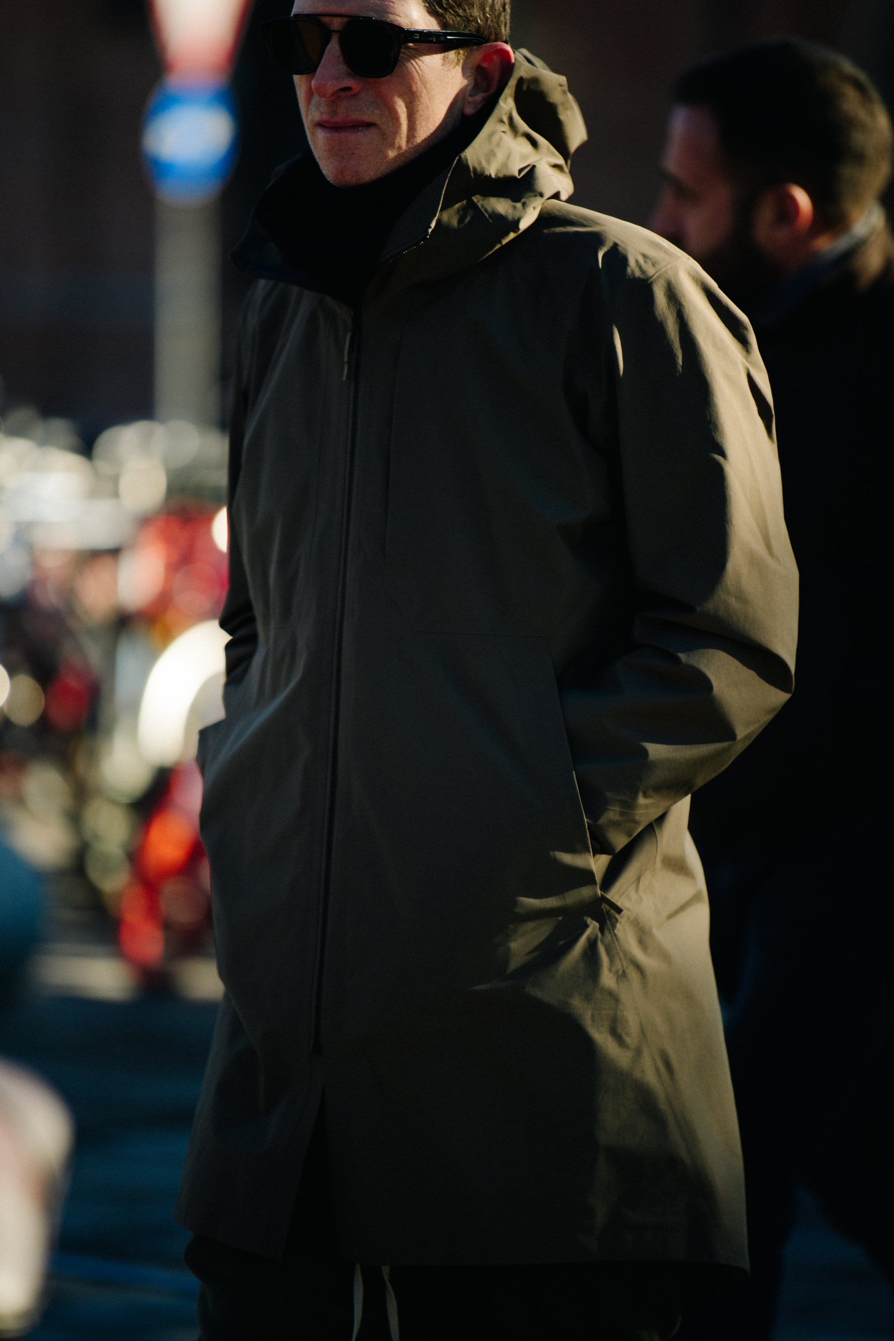 Man weasring green tech coat