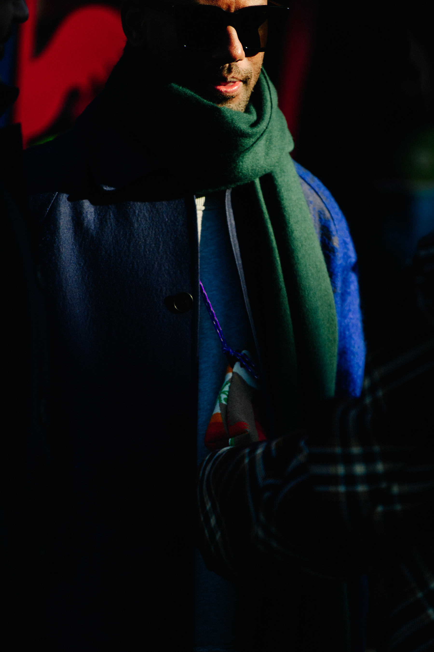 British man wearing green scarf