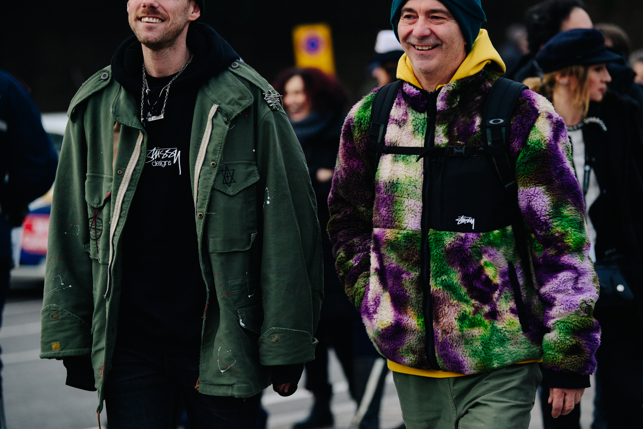 Two men wearing green jackets
