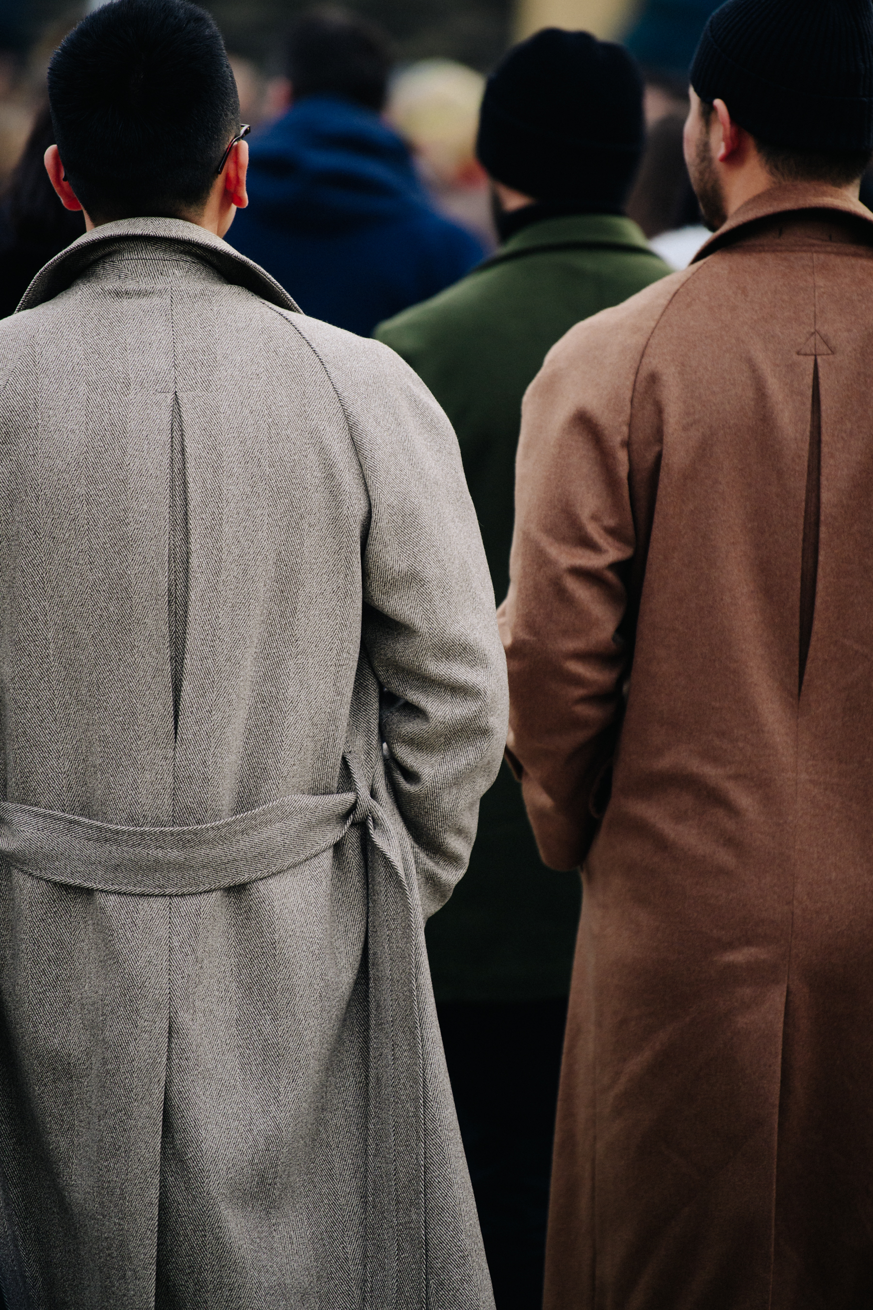 Two men wearing matching coats