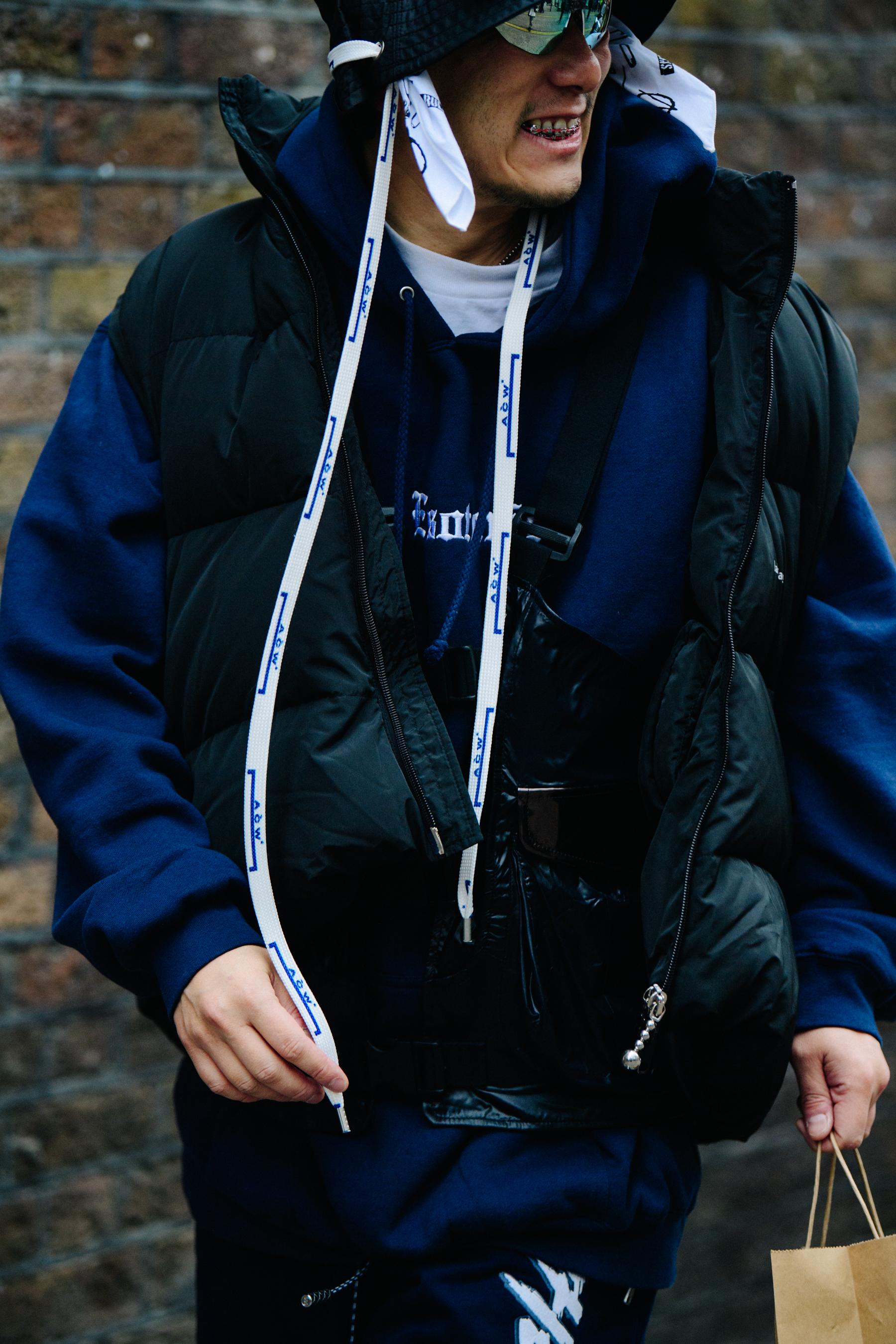 Asian man wearing A Cold Wall hat