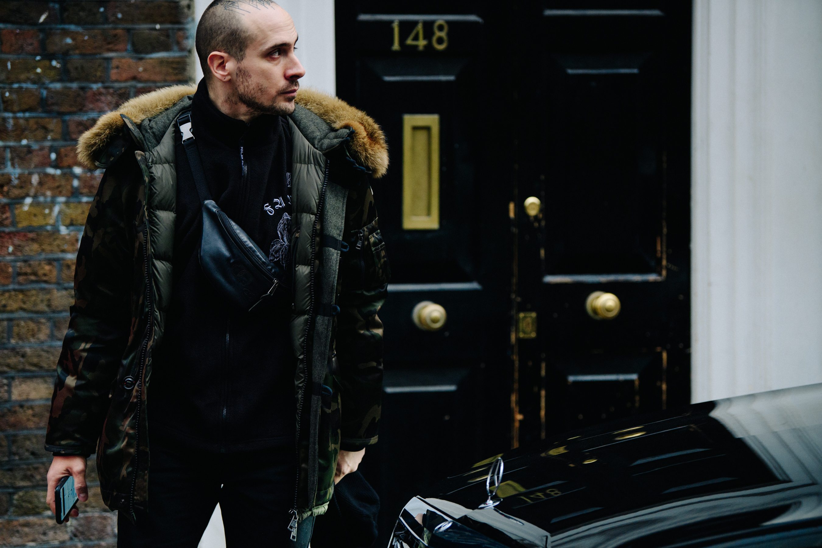 Tattoo artist wearing green winter coat
