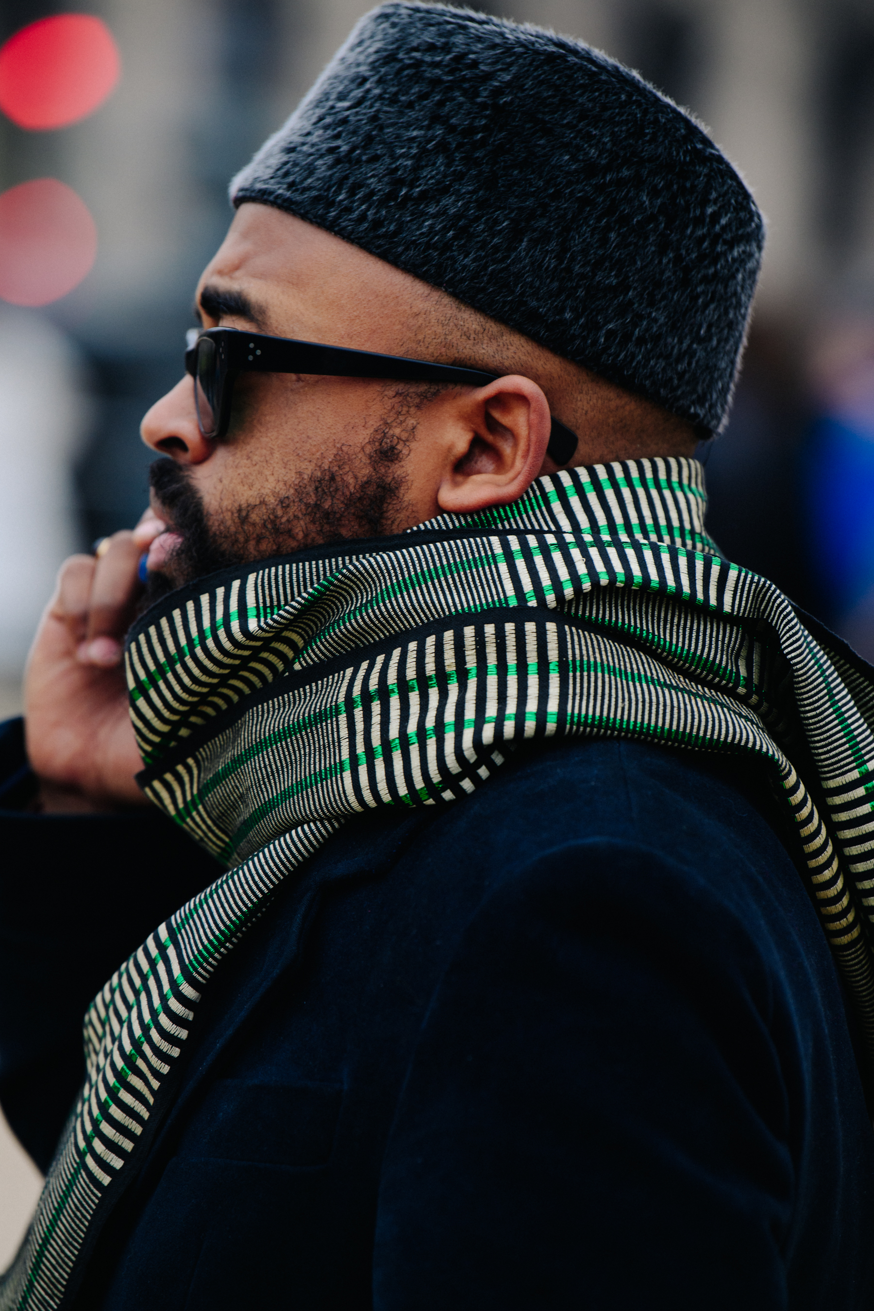 Man wearing white and green scarf
