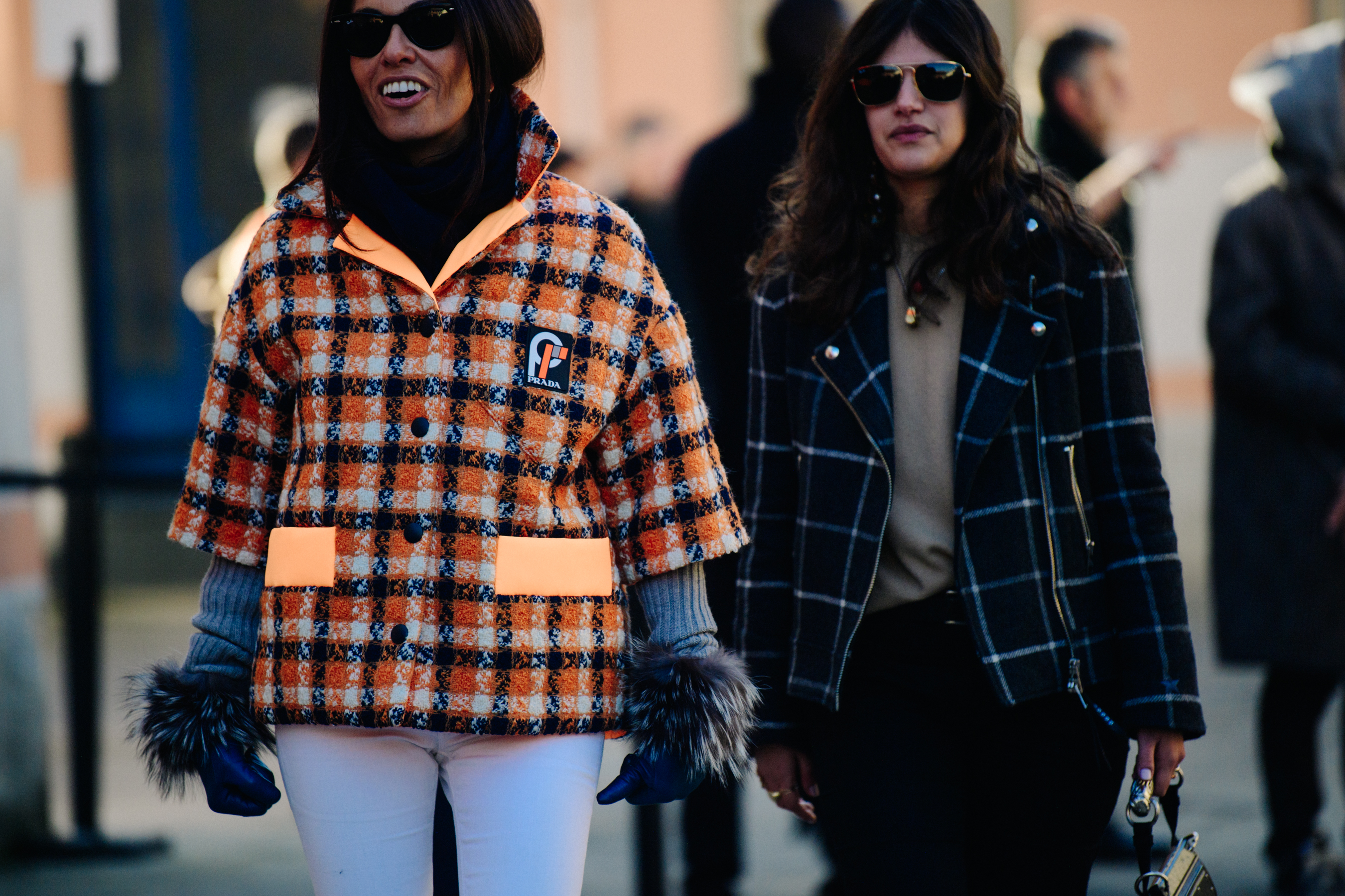 Two women wearing check jackets