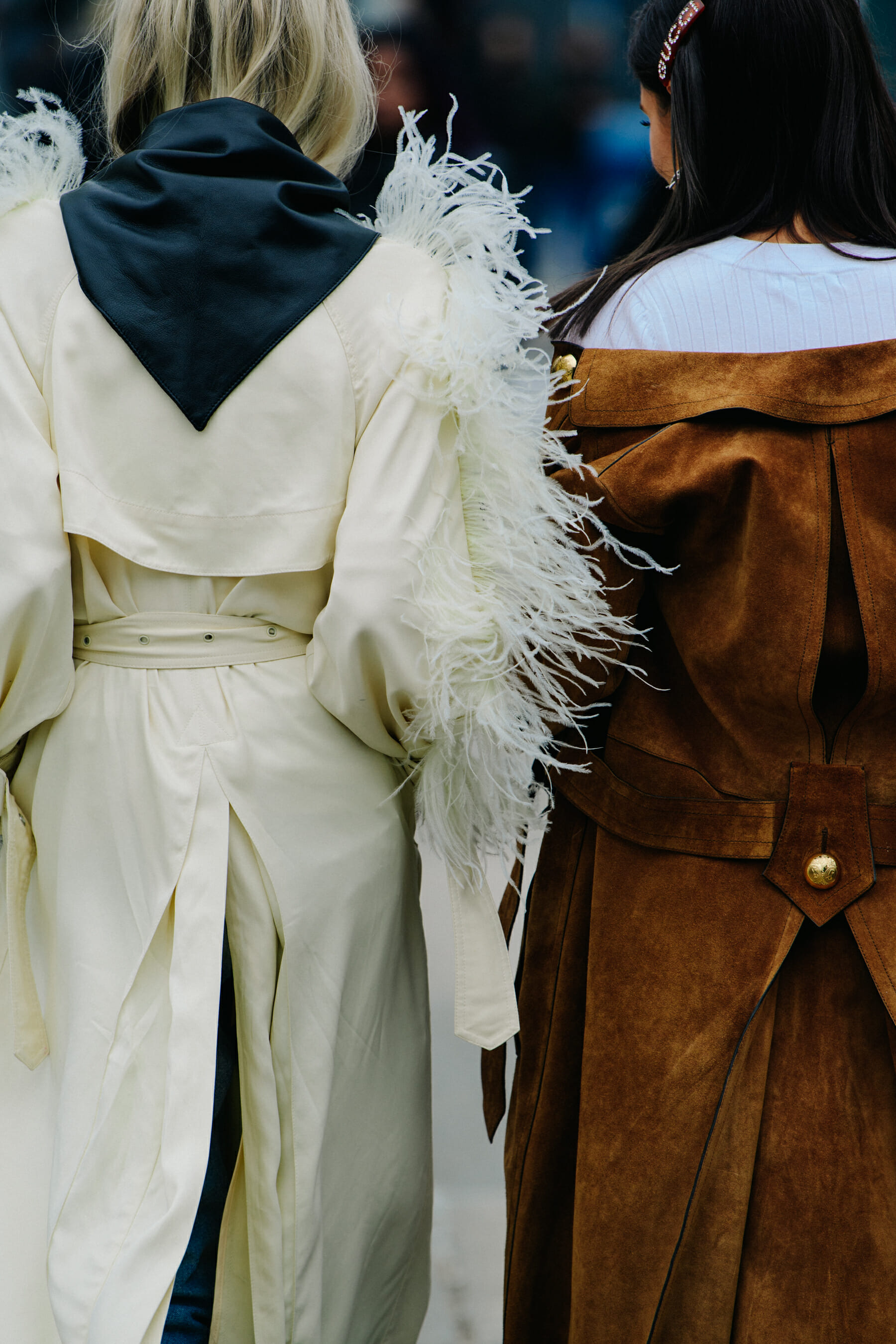 Two women wearing long coats