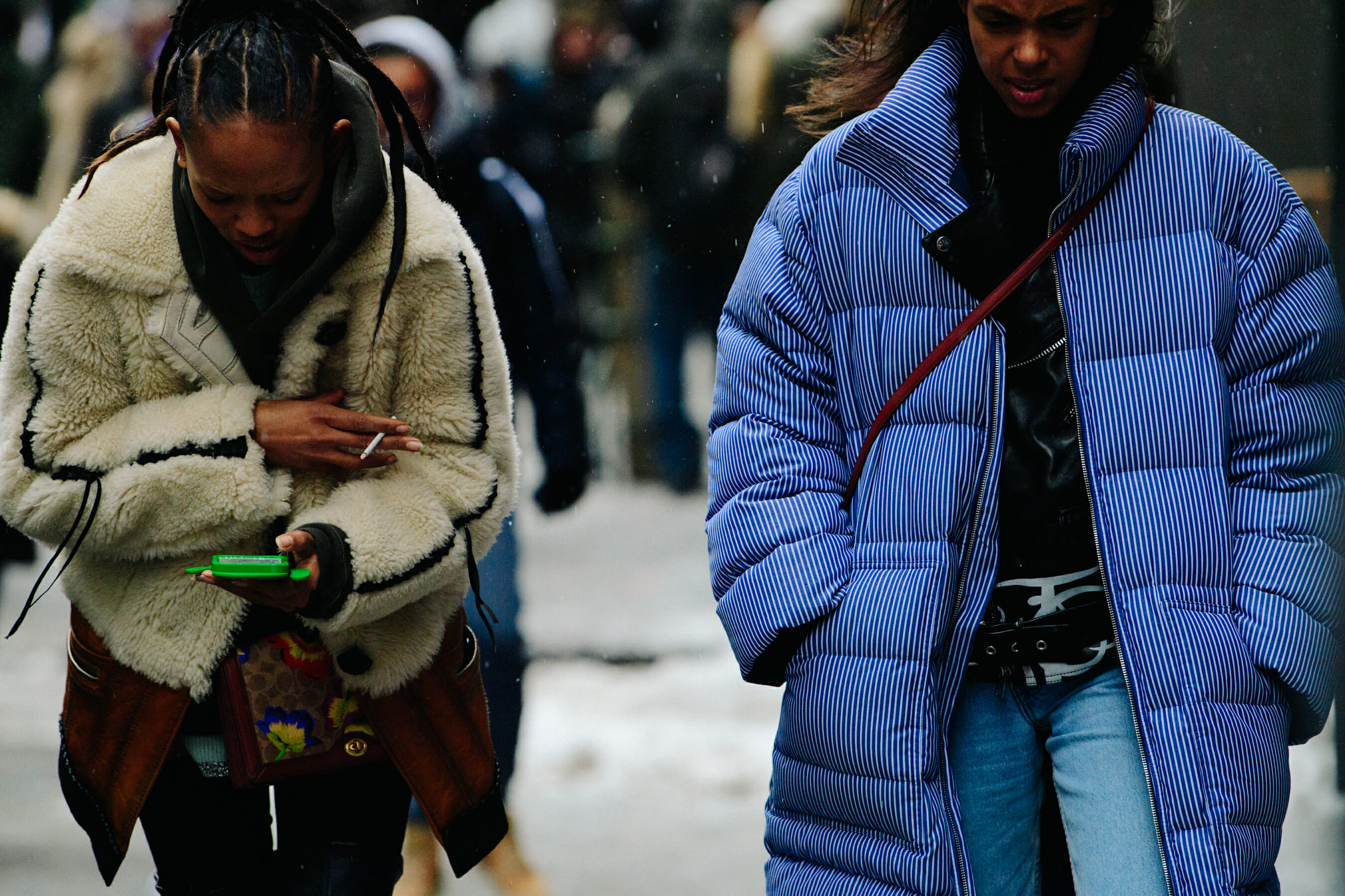 Two models wearing large coats