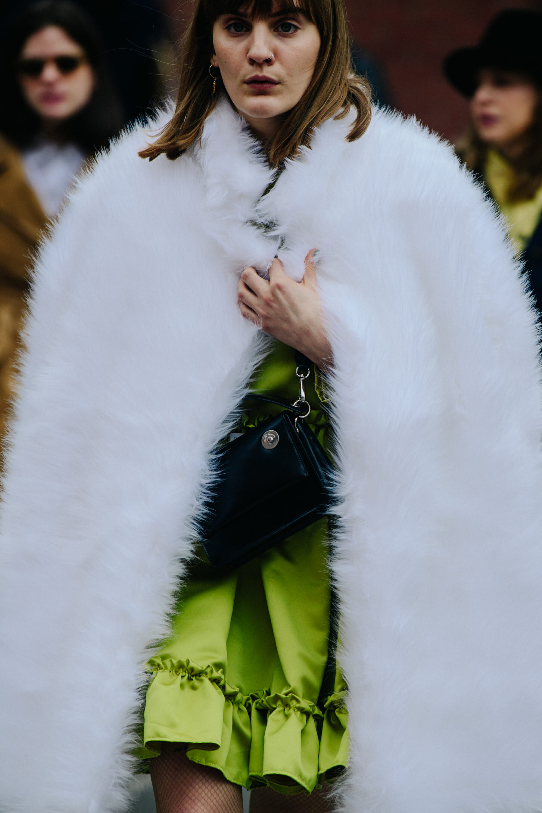 Woman wearing white fur coat