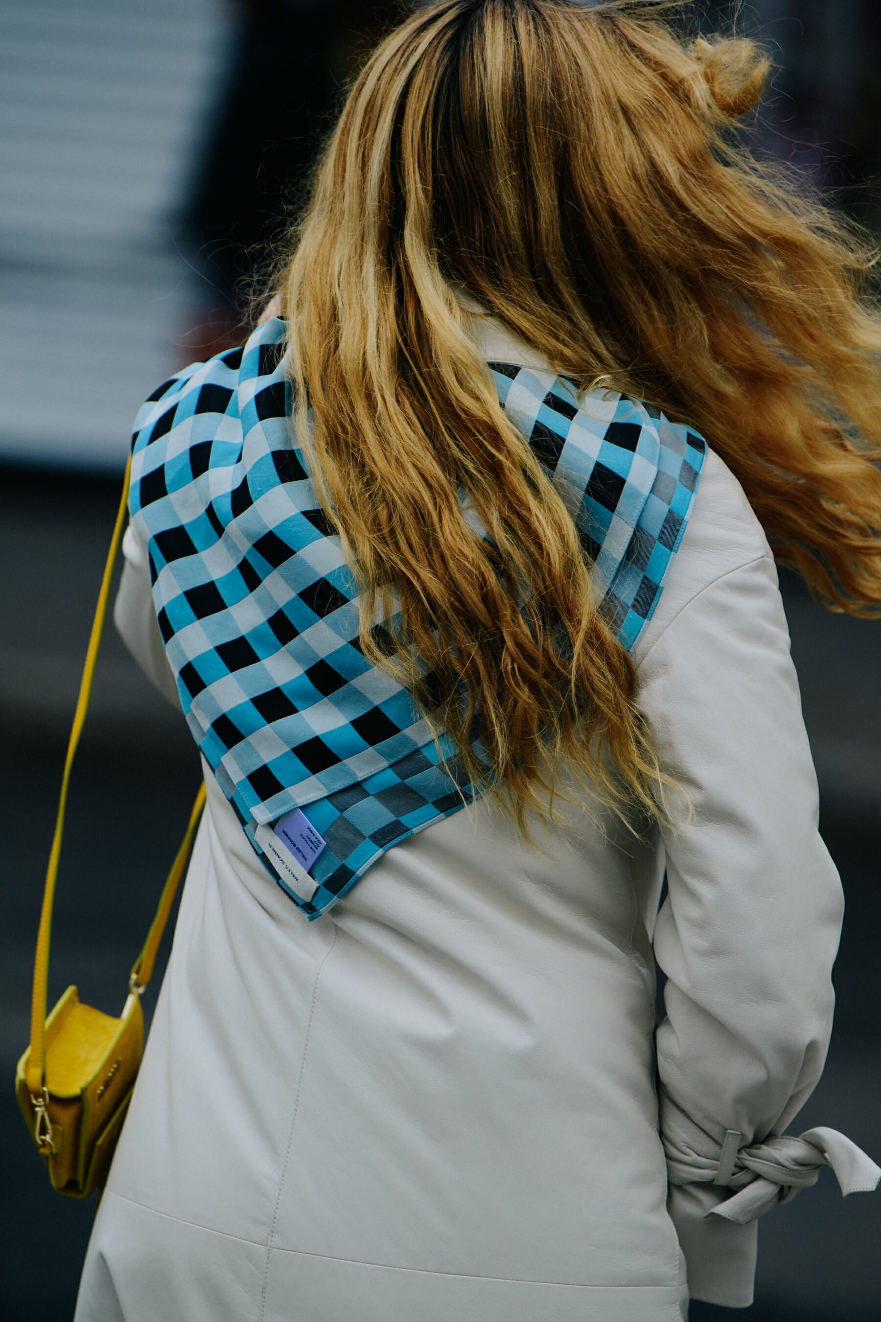 Woman wearing blue check scarf