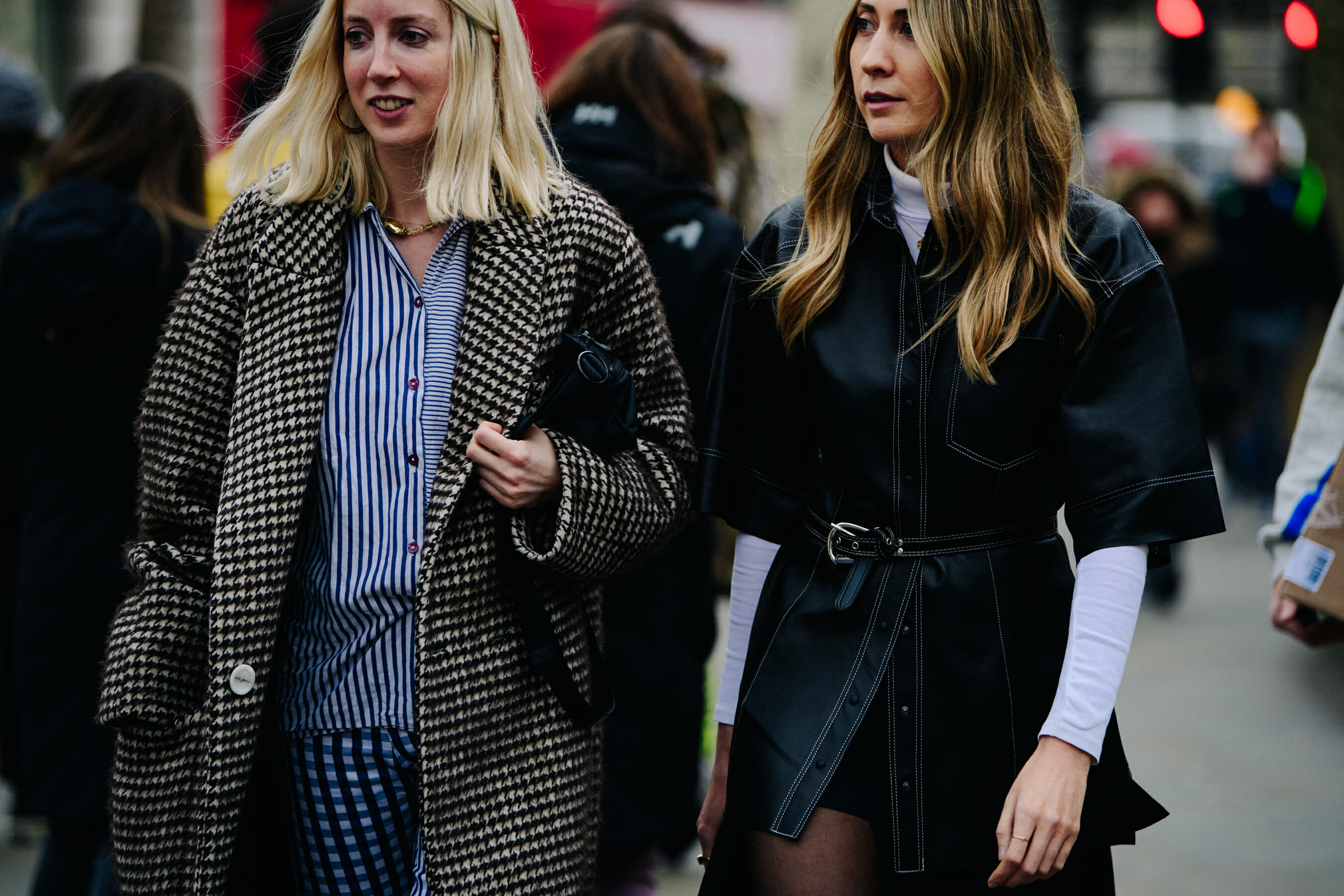 Two women wearing dark outfits