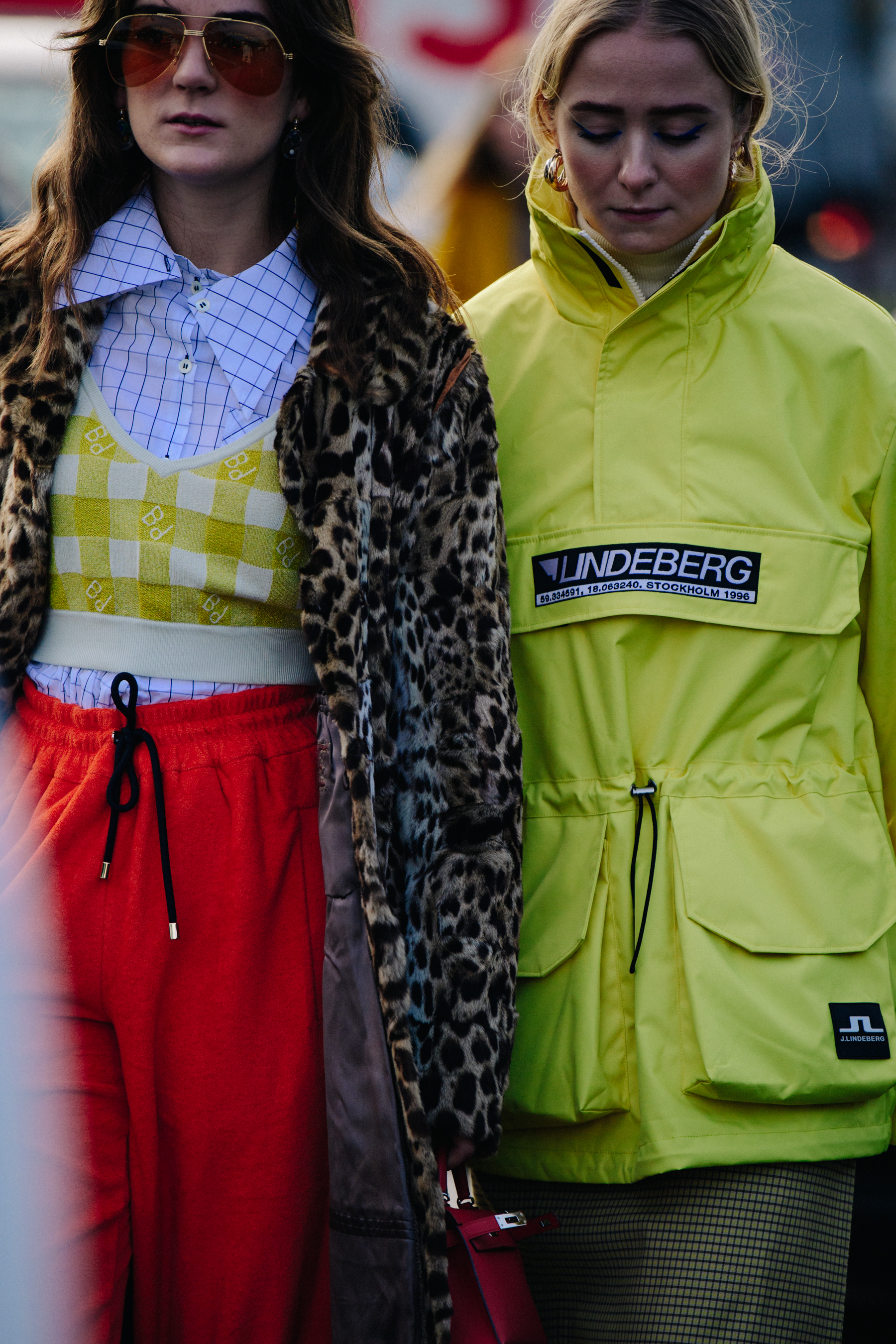 Two women wearing red and yellow