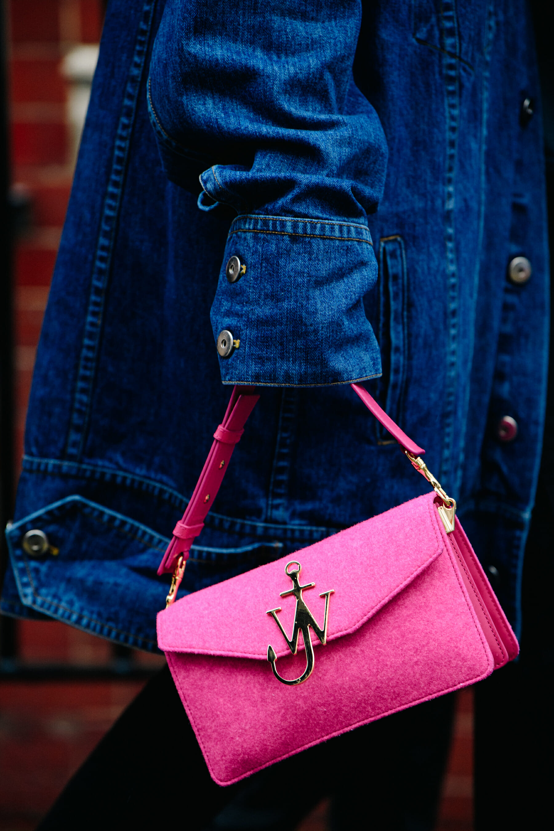 Woman carrying pink JW Anderson bag