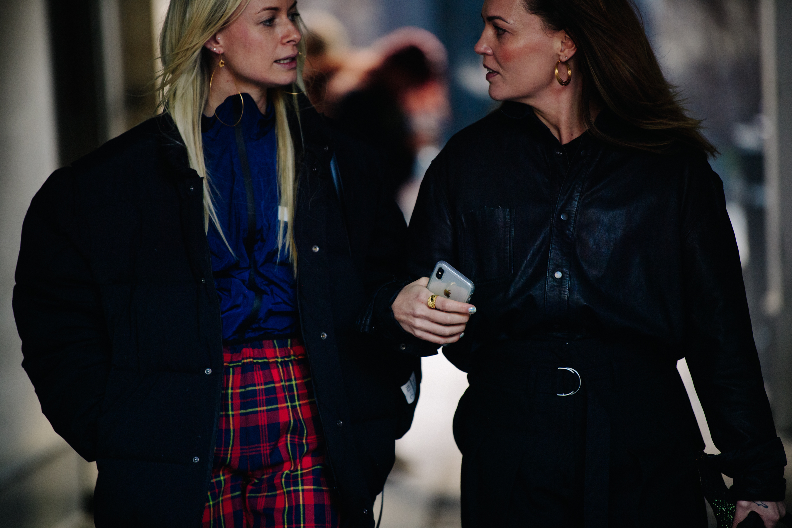 Two women wearing dark outfits