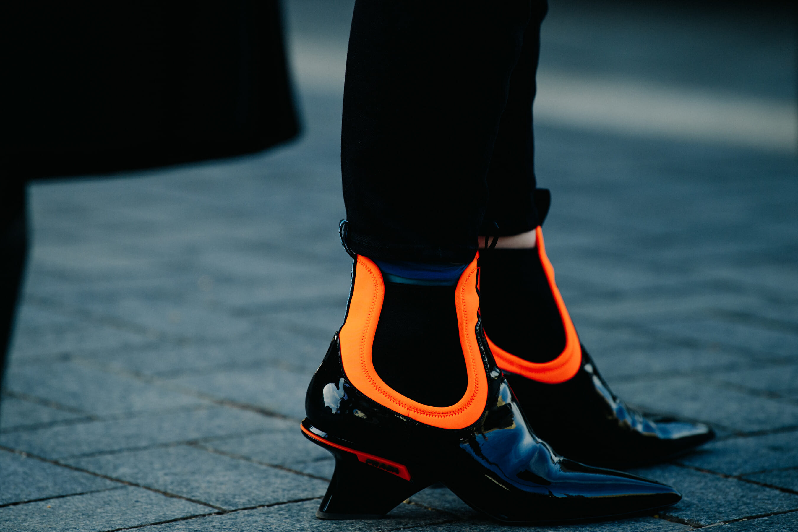 Woman wearing orange and black heels