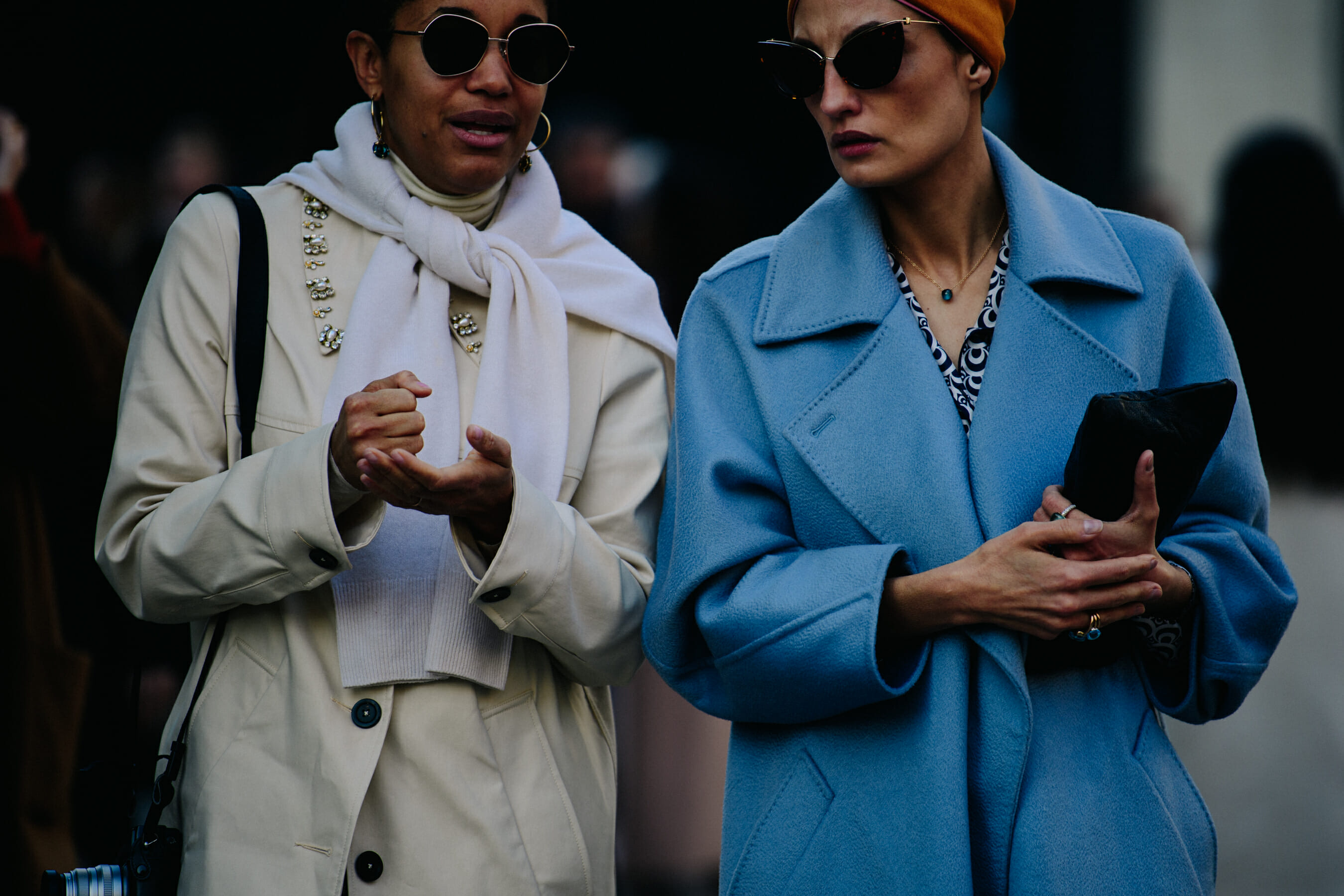 Two women wearing white and blue