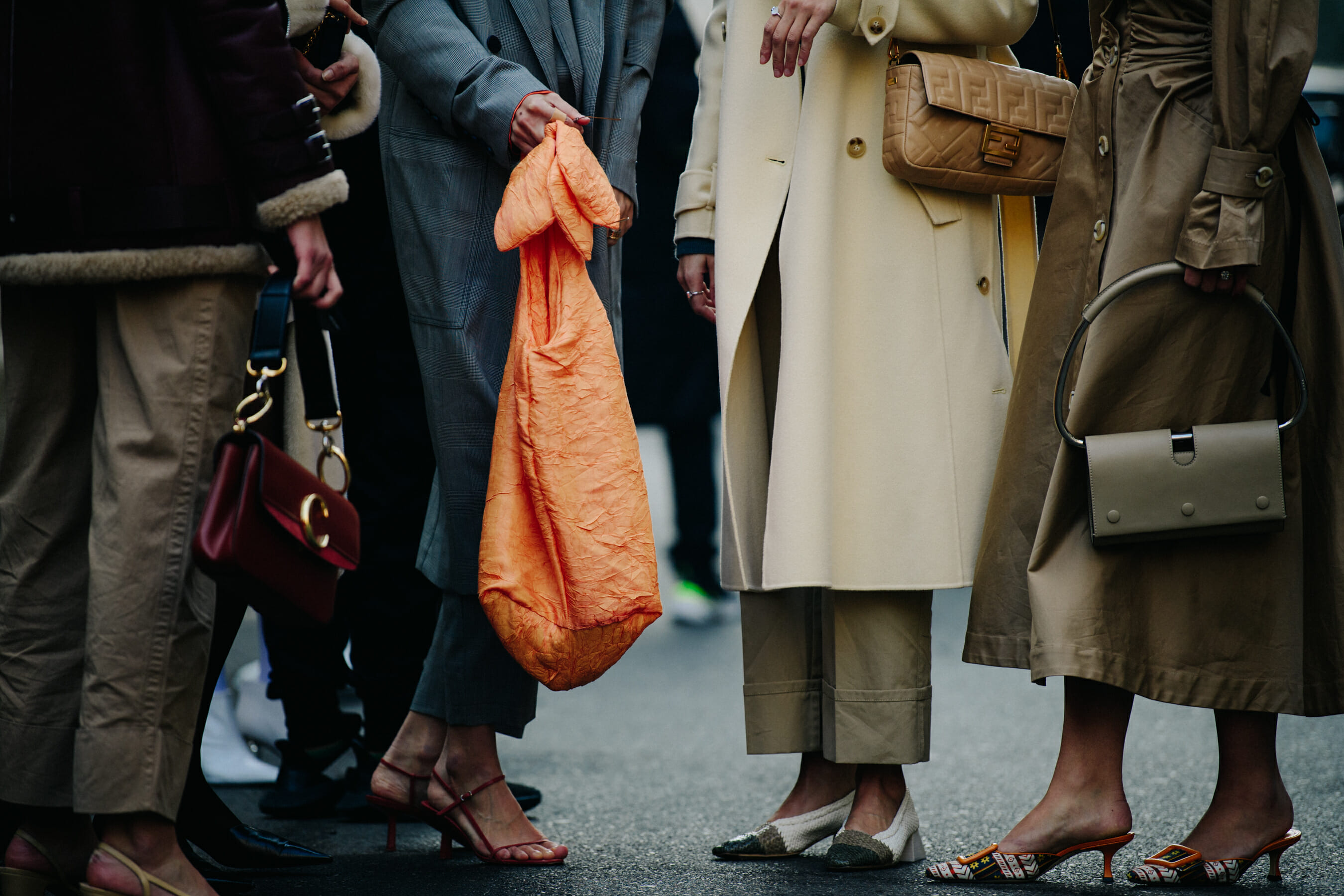 Group of women wearing long coats