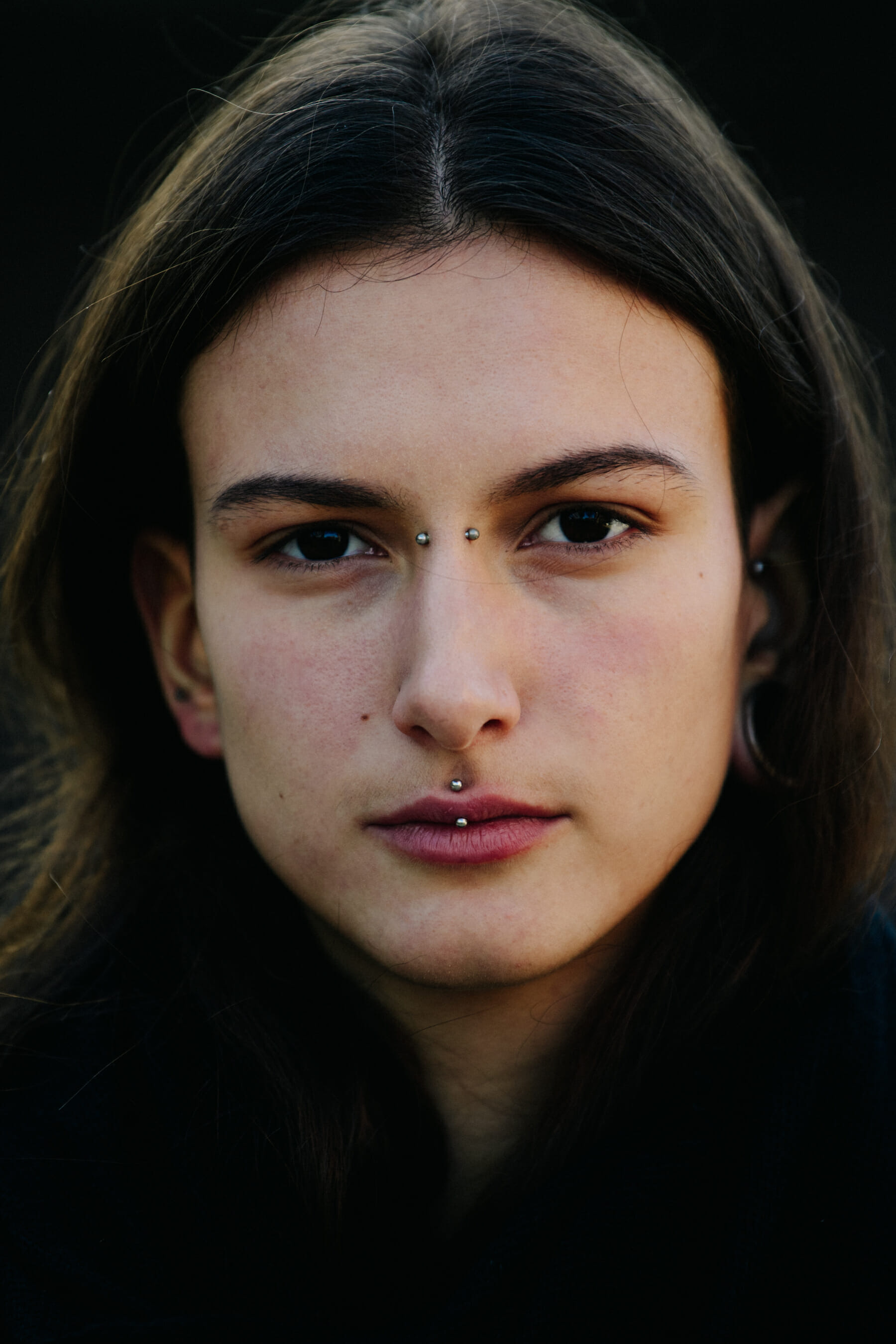 Portrait of model with face piercings