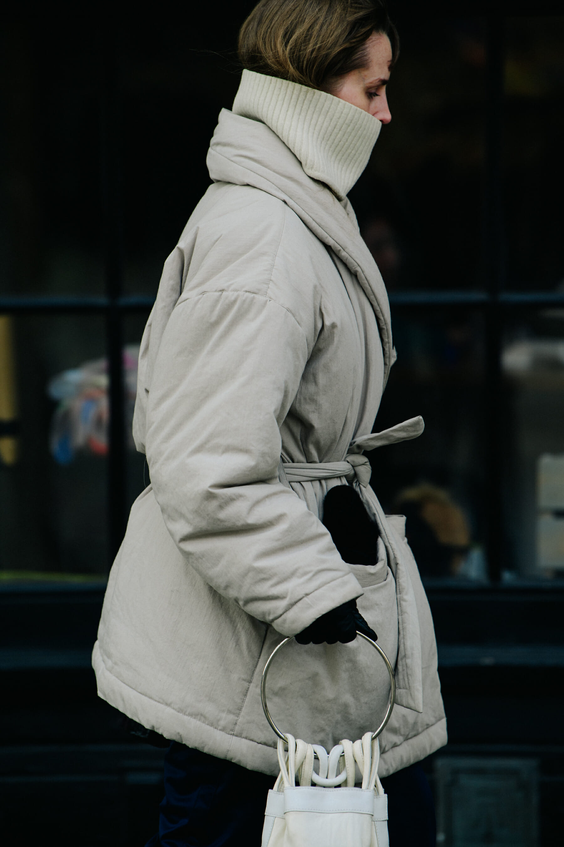 Woman wearing pale coat